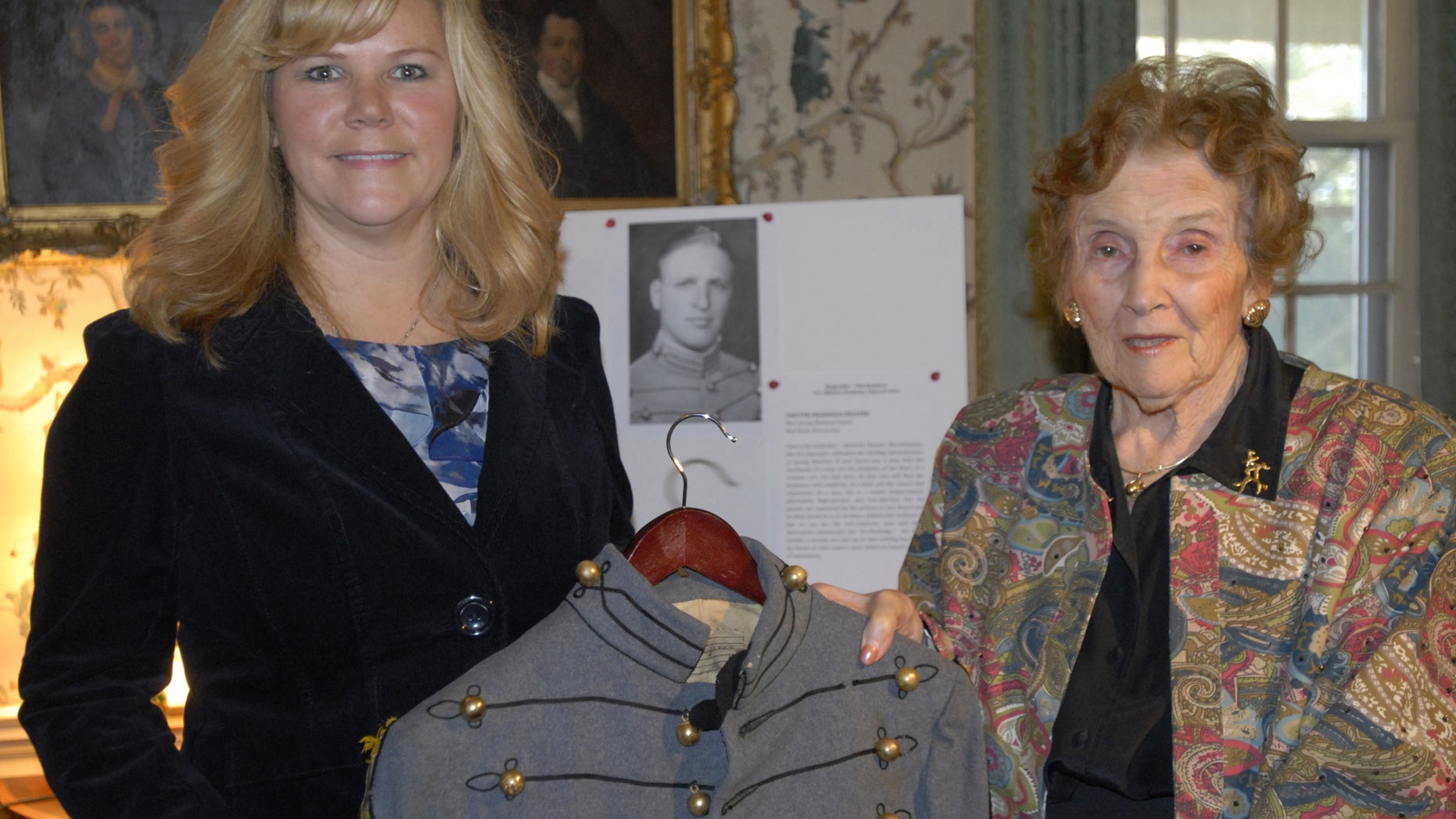 Nov. 28, 2012: In this photo taken in Onacock, Va., Donna Gugger, left, and Teresa deGavre, pose with the West Point uniform jacket Gugger found on a beach in New Jersey after Superstorm Sandy.