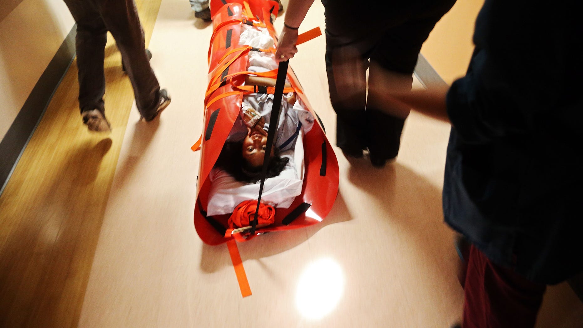 Hospital workers evacuate patient Deborah Dadlani from NYU Langone Medical Center during Hurricane Sandy the evening of October 29, 2012 in New York City.
