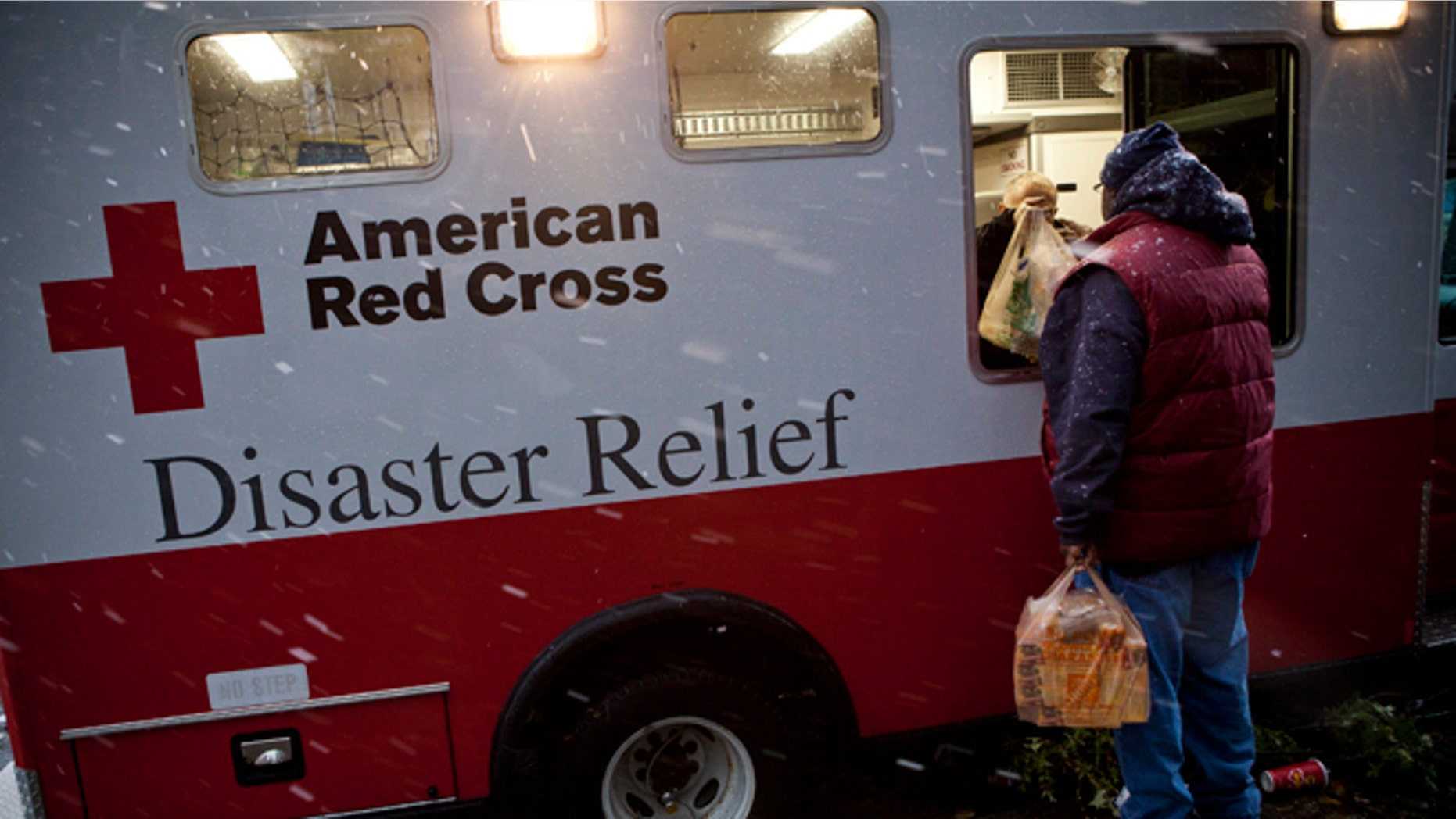 FILE: Nov. 7, 2012: A Hurricane Sandy victim receives a meal from an American Red Cross Disaster Relief truck, Red Hook, N.Y.