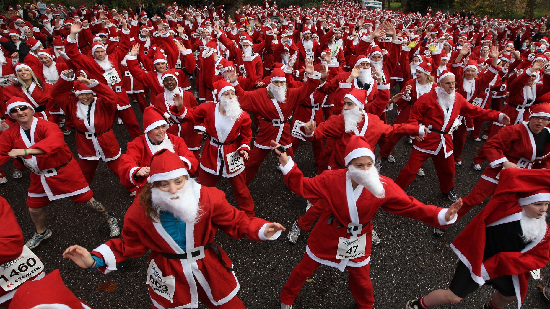 Charity runners dressed as Santa Claus warm up before taking part in the Disability Snowport UK fun run in London, England. (Photo by Peter Macdiarmid/Getty Images)