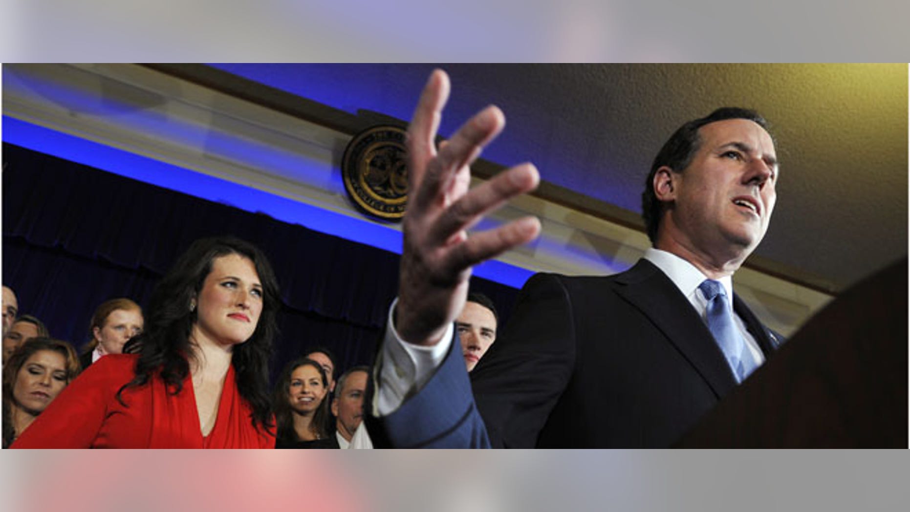 Former Pennsylvania Sen. Rick Santorum, right, speaks as his daughter, Elizabeth, looks on, Saturday, Jan. 21, 2012, in Charleston, S.C. (AP Photo/Rainier Ehrhardt)