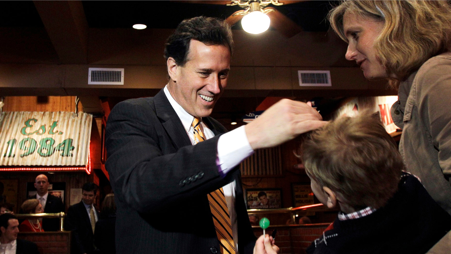 Republican presidential candidate, former Pennsylvania Sen. Rick Santorum, left, greets diners during a meet and greet at Corky's BBQ, Sunday, March 4, 2012, in Memphis, Tenn. (AP Photo/Eric Gay)