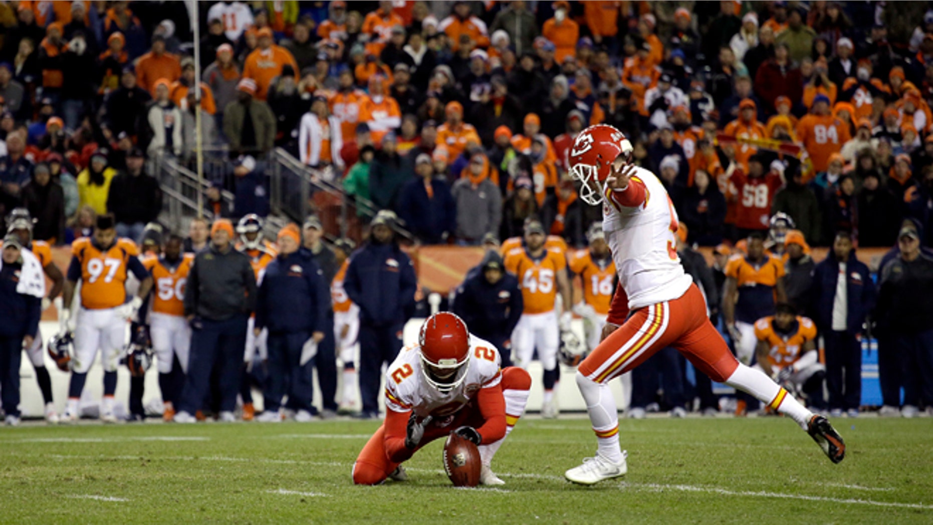 Kansas City Chiefs kicker Cairo Santos (5) kicks the game winning field goal as punter Dustin Colquitt (2) holds during overtime of an NFL football game against the Denver Broncos, Sunday, Nov. 27, 2016, in Denver. The Chiefs won 30-27 in overtime. (AP Photo/Joe Mahoney)
