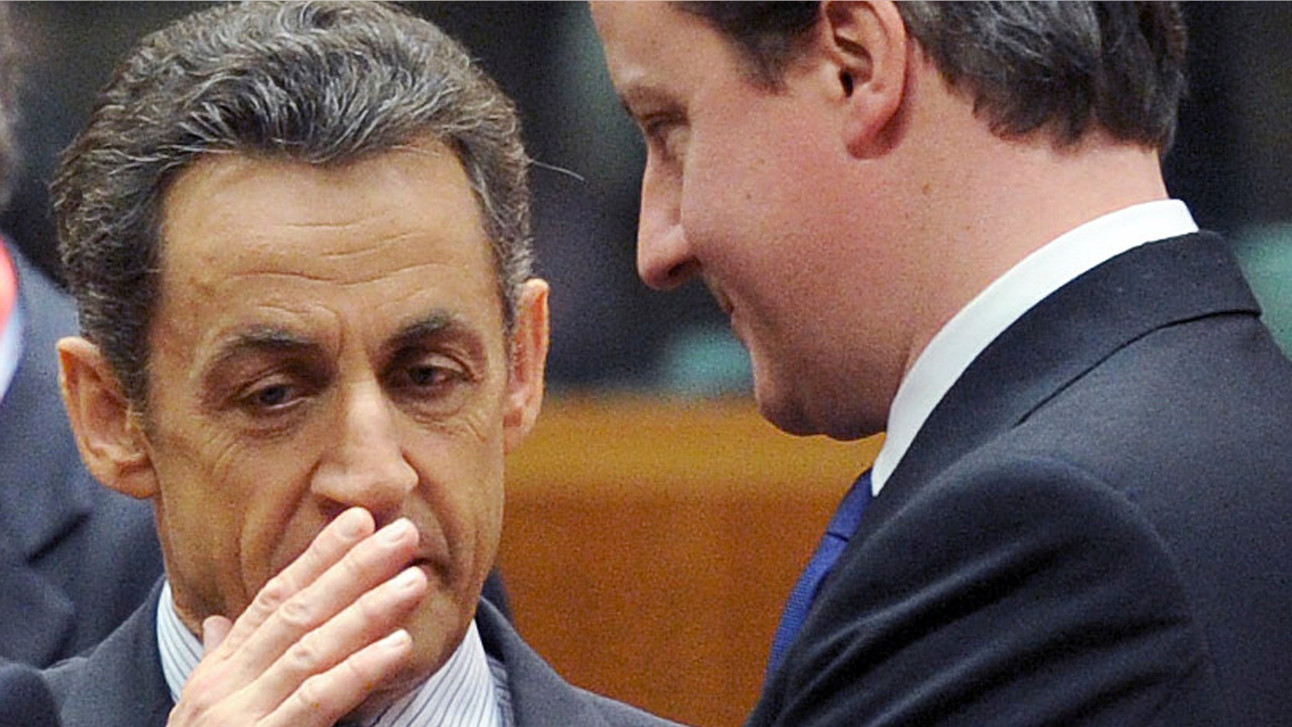 March 11: French President Nicolas Sarkozy, left, speaks with British Prime Minister David Cameron during an EU Summit in Brussels.
