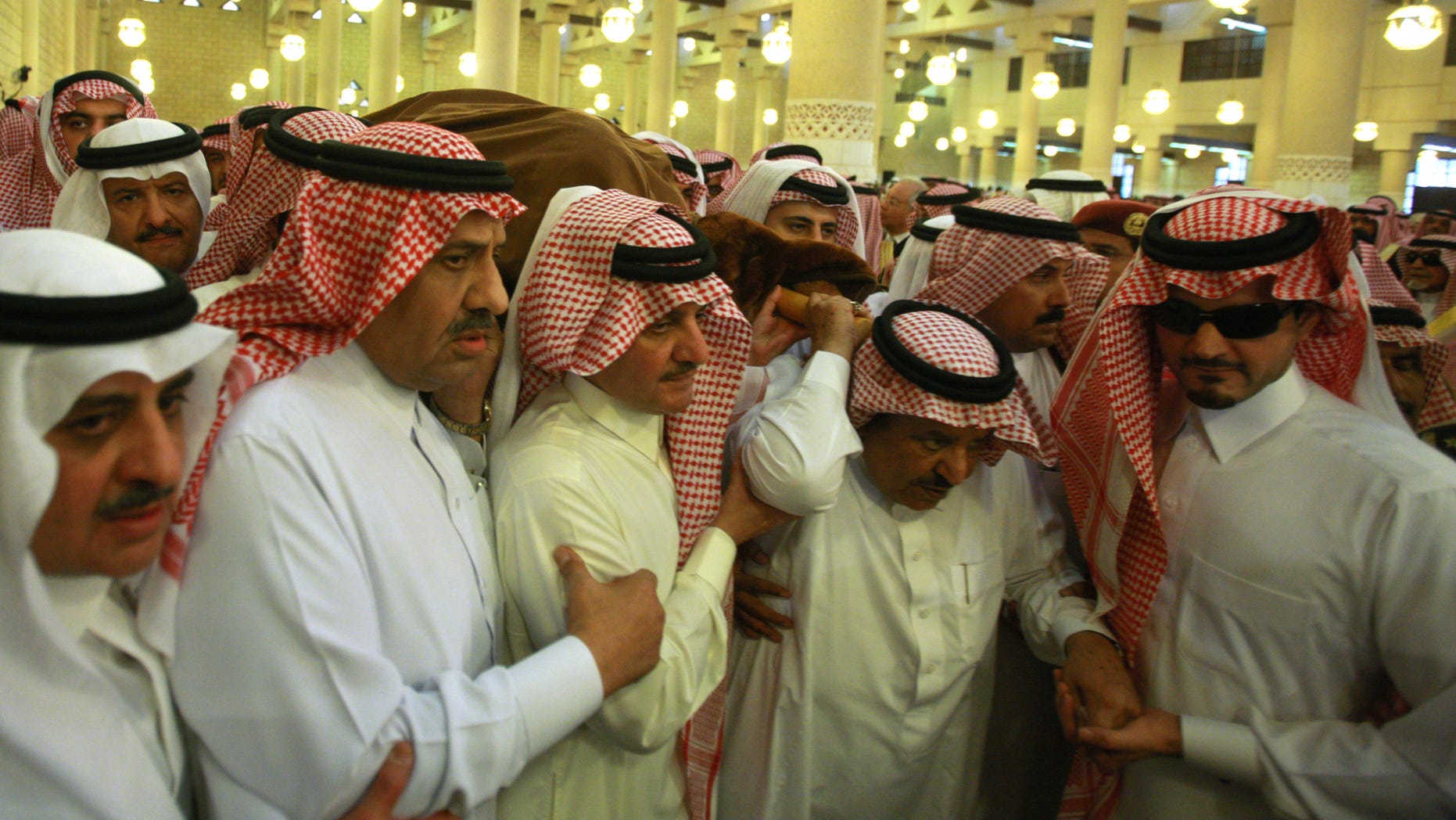 Oct. 25, 2011: Saudi Interior Minister Prince Nayef bin Abdul-Aziz Al Saud, second right, carries with Saudi Deputy Defense Minister Prince Khaled bin Sultan, second left, and other princes the shrouded body of late Crown Prince Sultan bin Abdul-Aziz Al Saud before performing special prayers at the Imam Turki bin Abdullah mosque in Riyadh, Saudi Arabia.