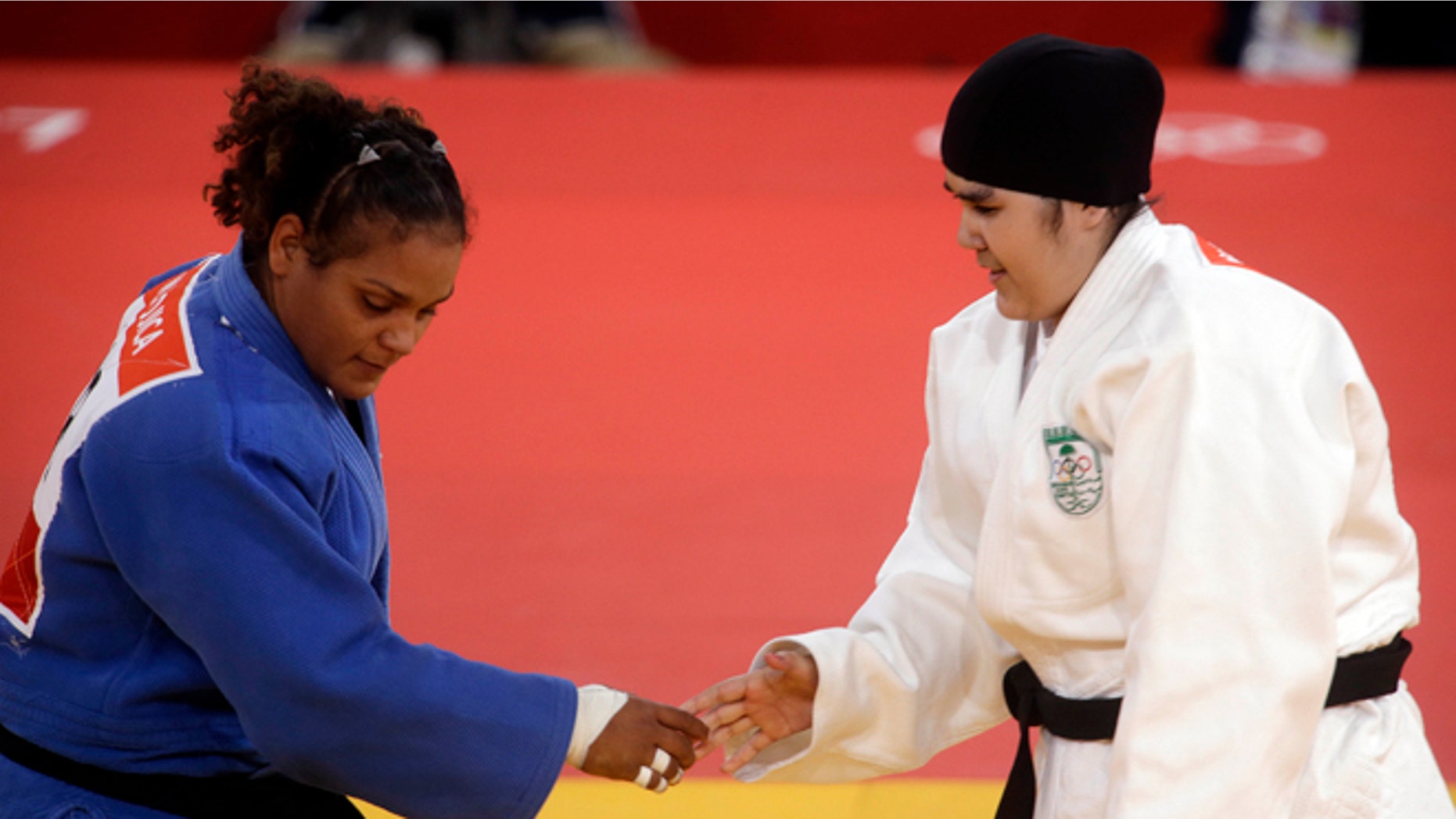 Saudi Arabia's Wojdan Shahrkani and Puerto Rico's Melissa Mojica compete during the women's 78-kg judo competition at the 2012 Summer Olympics, Friday, Aug. 3, 2012, in London. (AP Photo/Mike Groll)