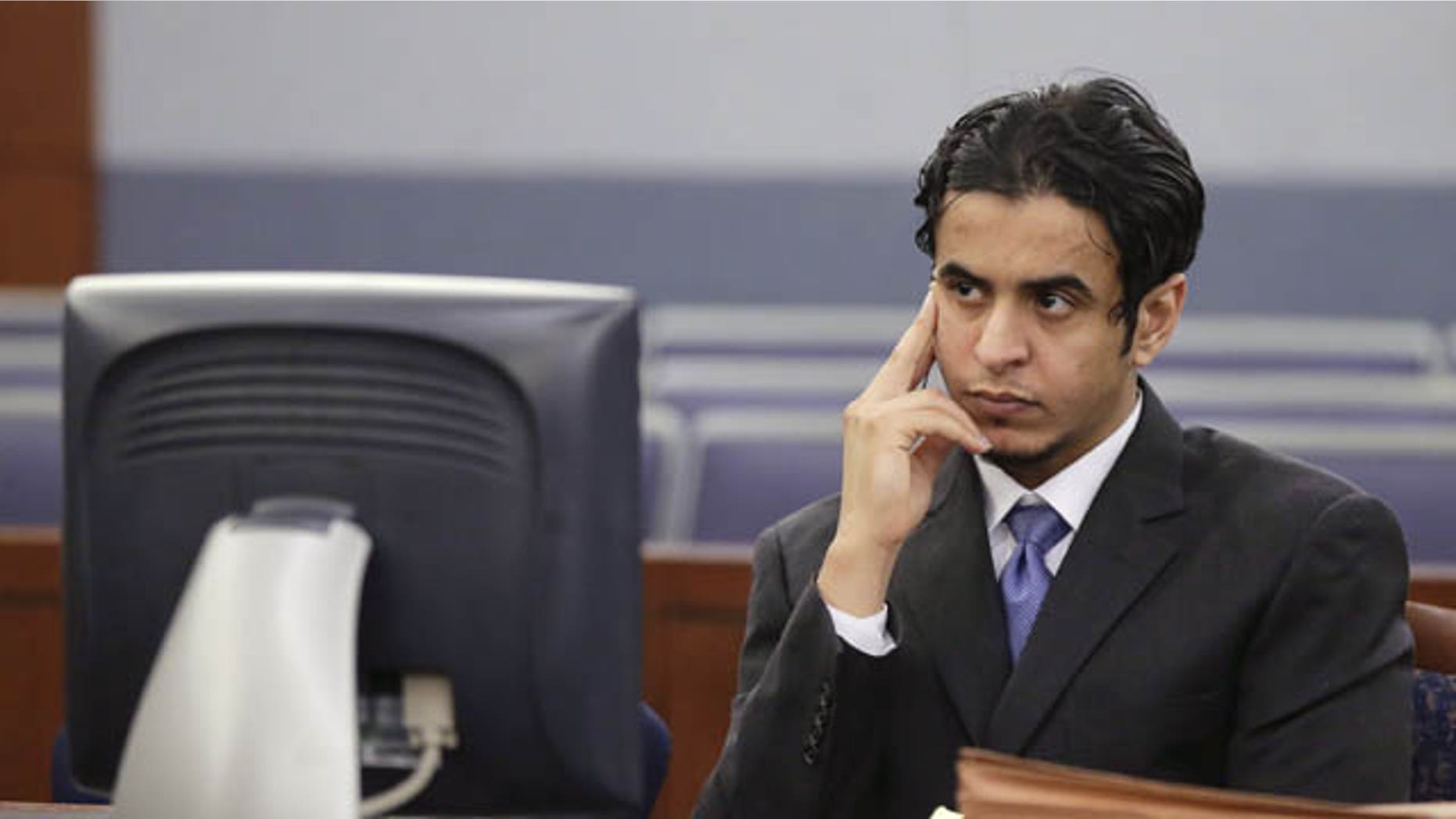October 11, 2013: Defendant Mazen Alotaibi, listens to comments by Judge Stefany Miley during the jury selection process for his trial Friday at Justice Court in Las Vegas. The 24-year-old Saudi Arabian air force sergeant is charged with raping a 13-year-old boy at a Las Vegas Strip hotel. (AP Photo/Julie Jacobson)