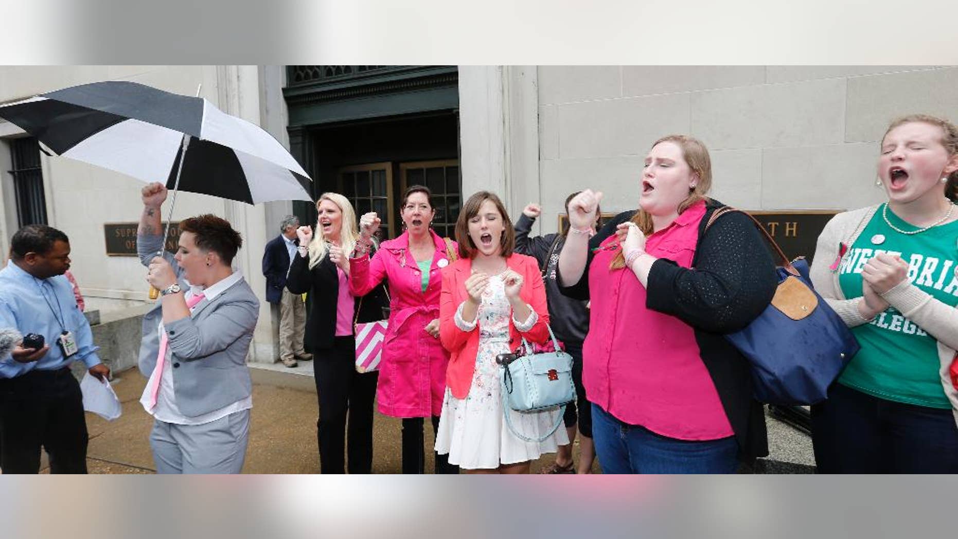 FILE - In a Thursday, June 4, 2015 file photo, Sweet Briar College alumni do a cheer for the school after a hearing on the closure of Sweet Briar college at the Supreme Court of Virginia in Richmond, Va. Sweet Briar President Phillip C. Stone marvels at the energy of passionate alumnae who helped save the school just a few months ago from closure. But he knows without a serious change in fortune, the salvation will only be temporary. (AP Photo/Steve Helber, File)