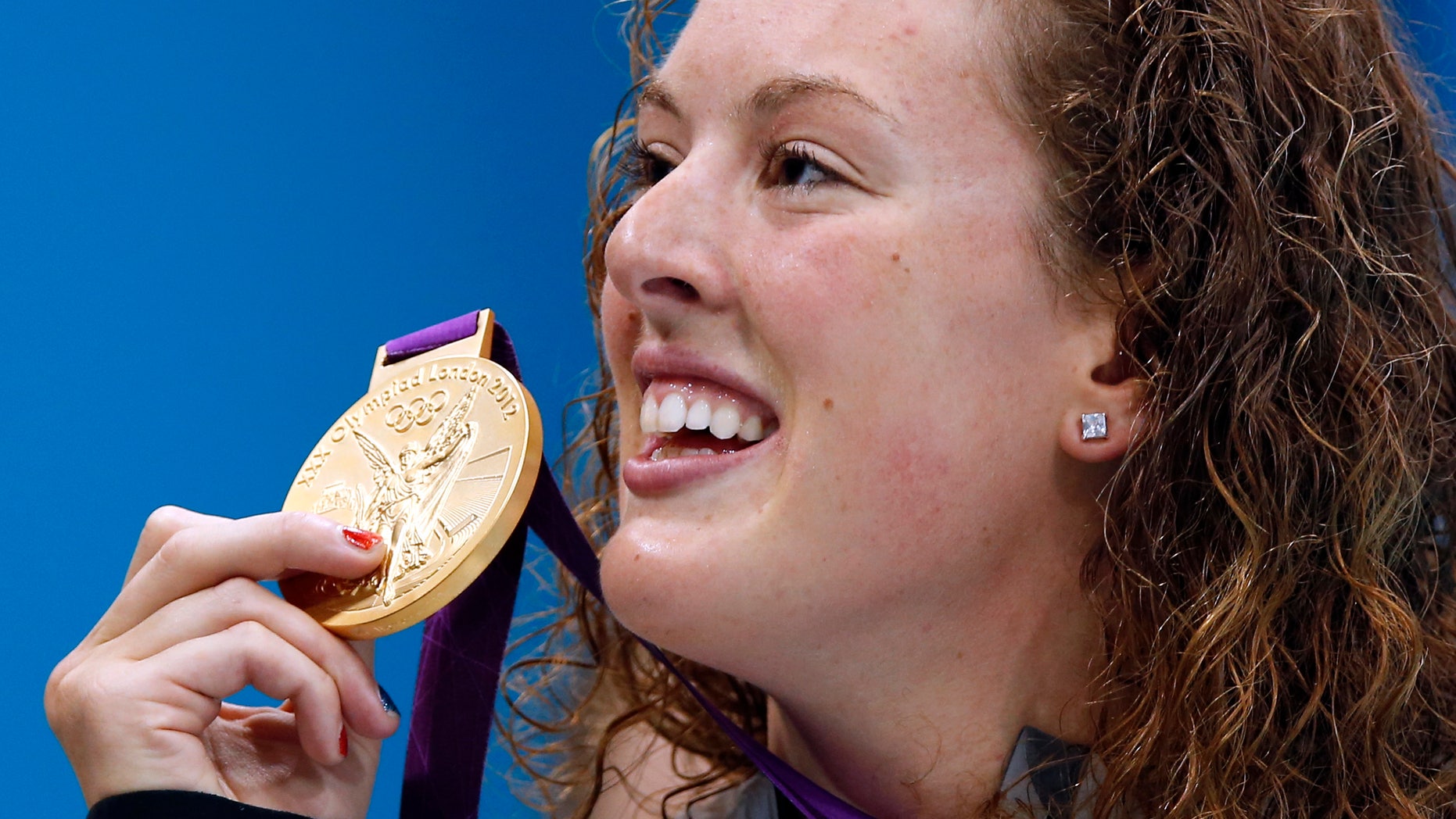 July 31, 2012: In this file photo, United States' Allison Schmitt holds her gold medal aloft after winning the women's 200-meter freestyle swimming final at the Aquatics Centre in the Olympic Park during the 2012 Summer Olympics in London.