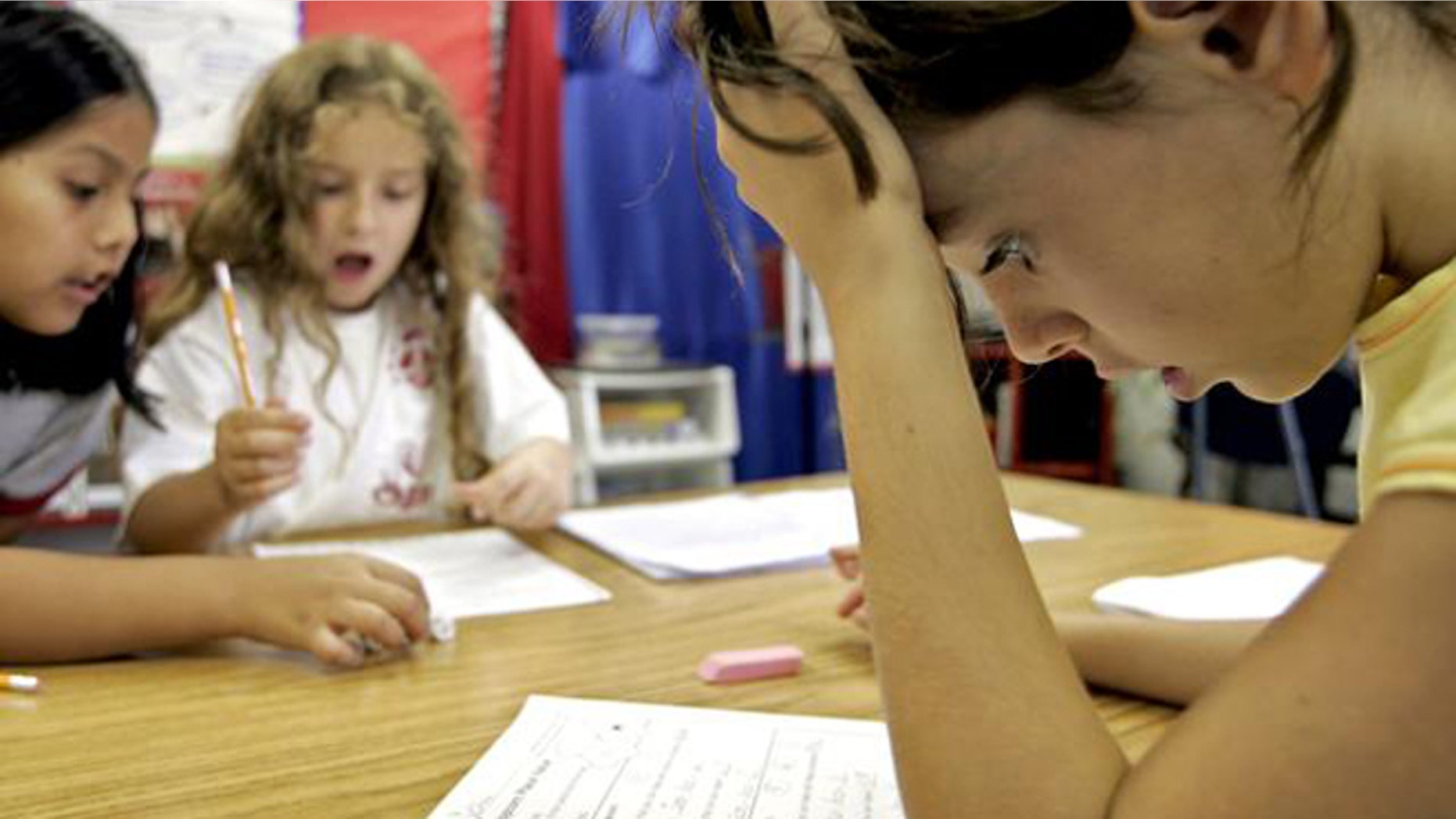 Third grade student Georgia Allin, right, participates in a math exercise with classmates Maria Ortiz-Pozo, left, and Erin Rieman, center, at Barcroft Elementary School in Arlington, Va., Tuesday, Aug. 16, 2005, outside Washington. People in this country have a love-hate relationship with mathematics, a favorite subject for some but just a bad memory for many others, especially women, according to an AP-AOL poll. (AP Photo/Charles Dharapak)