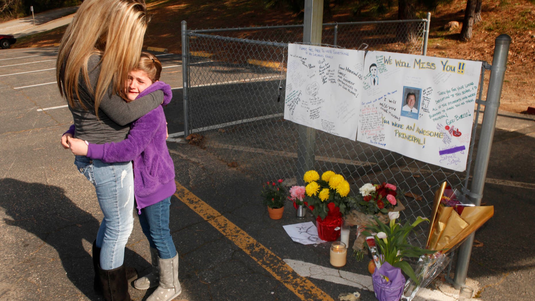 Feb. 3: Lindsay Byers comforts her daughter, Chloe Harbas, 8, after she signed a memorial for Sam LaCara, 50, the principal of the Louisiana Schnell School in Placerville, Calif. who was shot and killed at the school the previous day. The alleged gunman, school janitor John Leubbers, was taken into custody about an hour after the shooting.