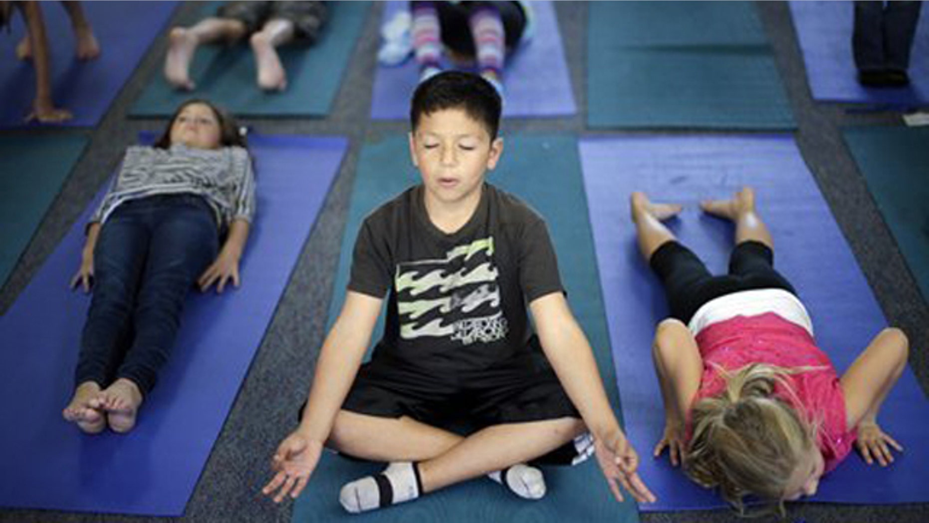 Dec. 11, 2012: Fourth grader Miguel Ruvalcaba holds a pose during a yoga class at Capri Elementary School in Encinitas, Calif.