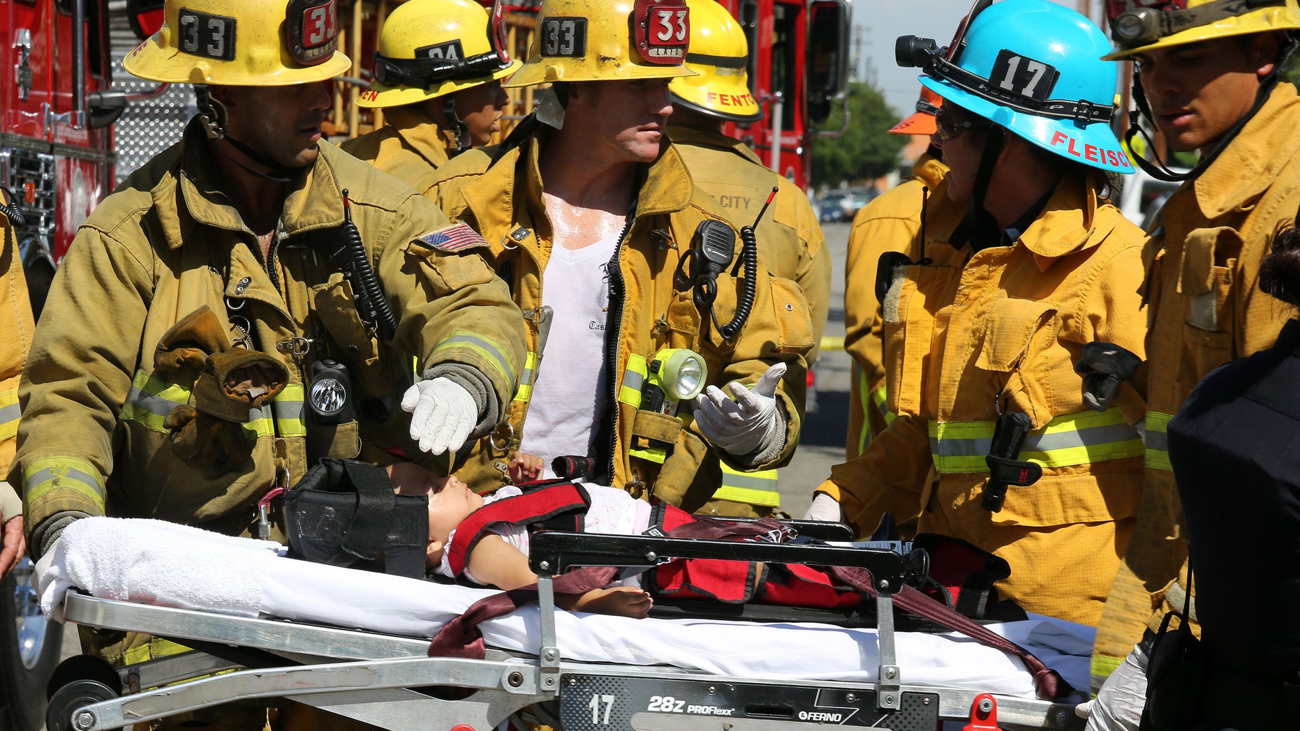 Aug. 29, 2012: Los Angeles City Firefighter paramedics assist a child, one of eight people injured when a car sped onto a sidewalk and plowed into a group of parents and children outside Main Street Elementary school in Los Angeles.