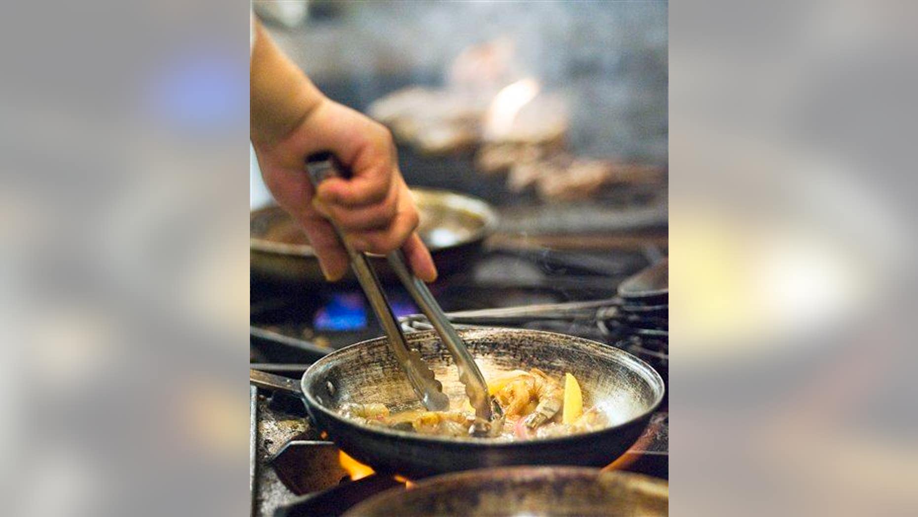 This photo taken Dec. 11, 2009 shows a busy kitchen at the new restaurant Om, an Indian restaurant in Minneapolis Minn.