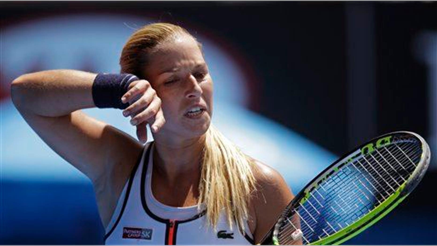 Dominika Cibulkova of Slovakia wipes the sweat from the face as she plays Serena Williams at the Australian Open this year.