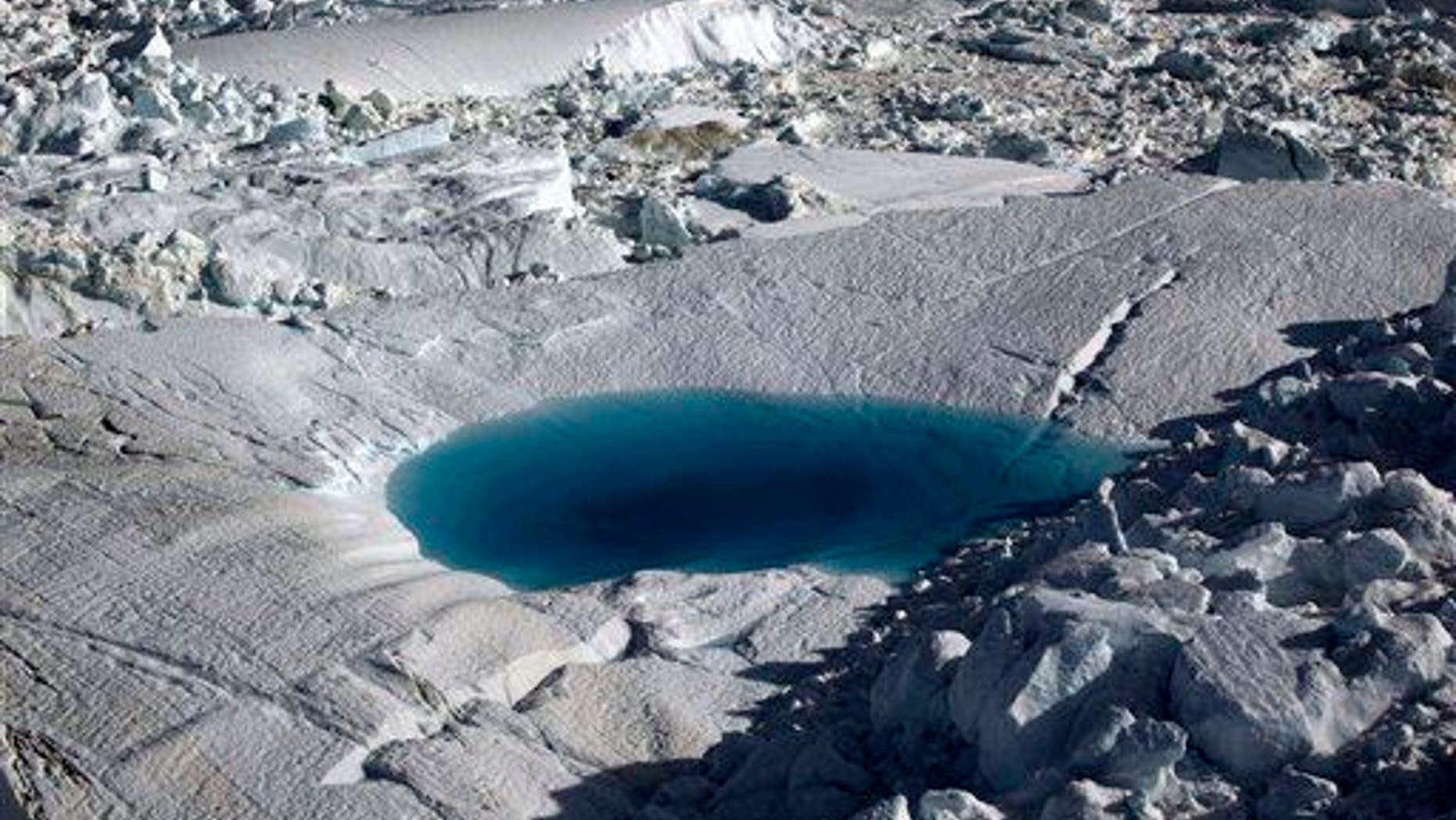 In this July 19, 2011 file photo, a large melt pool forms in the Ilulissat ice fjord below the Jakobshavn Glacier, at the fringe of the vast Greenland ice sheet.