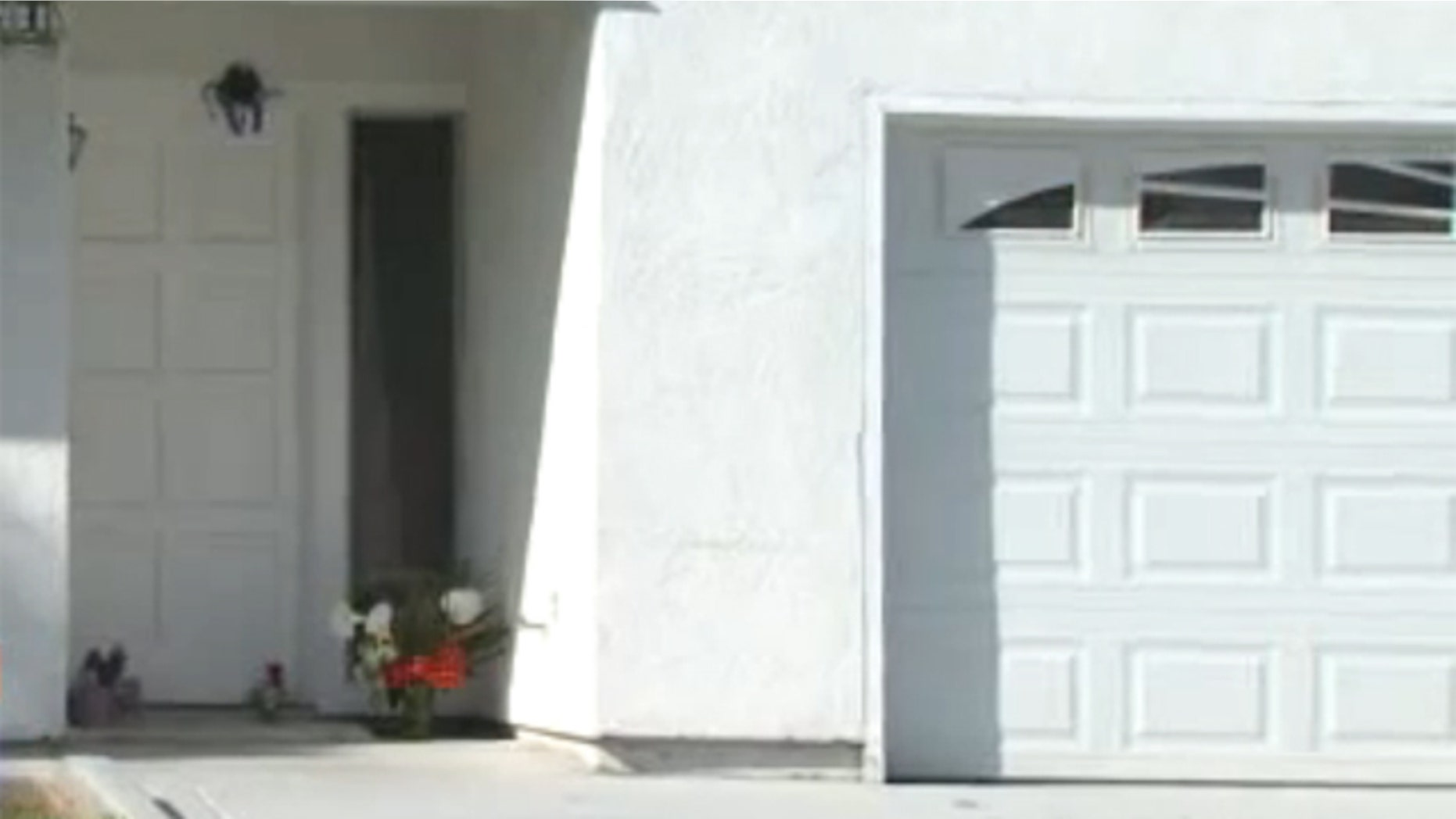 Mar. 24, 2012: Flowers lay in front of a home where a San Diego-area mother was beaten Wednesday morning.