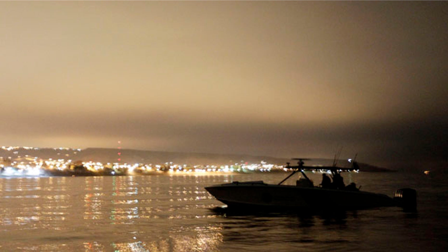 July 30: A U.S. Customs and Border Protection speedboat is silhouetted by the lights of Tijuana, Mexico, along of the coast of San Diego. California-Mexico coastline is the new frontier for illegal immigrants entering the United States a roughly 400-square-mile ocean expanse that stretches from a bullring on the shores of Tijuana, Mexico, to suburban Los Angeles. (AP)