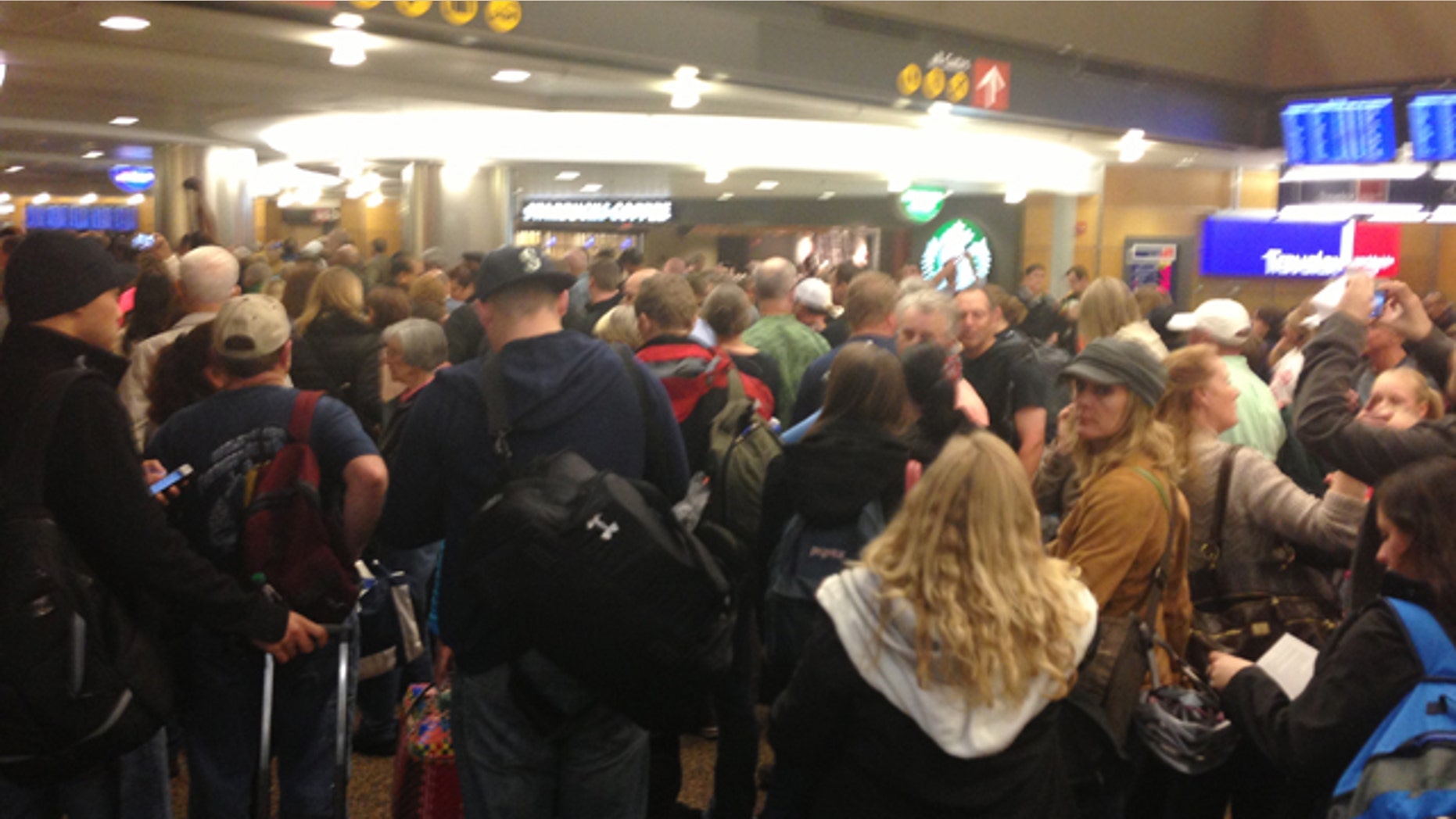 Mar. 19, 2013: Passengers wait at Seattle-Tacoma International Airport after a security breach.
