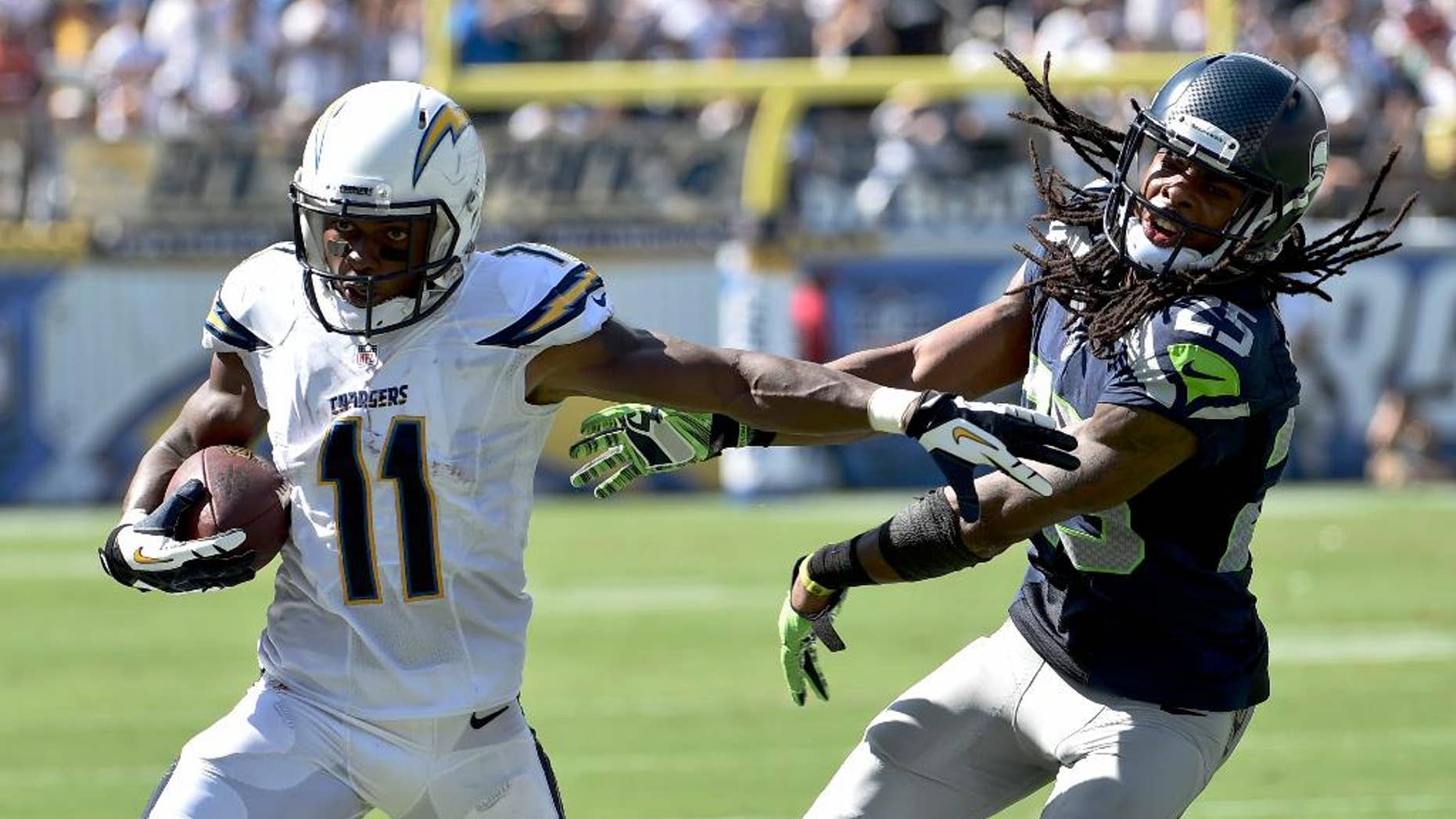 San Diego Chargers wide receiver Eddie Royal, left, pushes off Seattle Seahawks cornerback Richard Sherman during the second half of an NFL football game on Sunday, Sept. 14, 2014, in San Diego. (AP Photo/Denis Poroy)