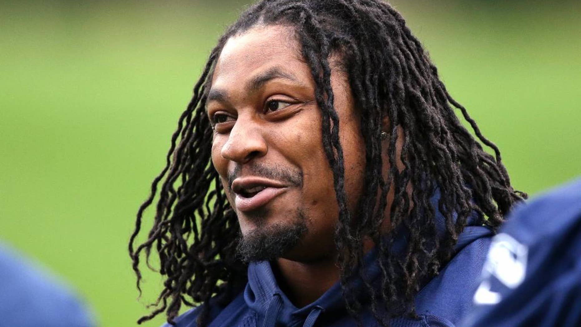 FILE - In this June 17, 2014 file photo, Seattle Seahawks' Marshawn Lynch smiles at a football minicamp practice that he watched from the sidelines in Renton, Wash. Lynch has been the workhorse Seattle has leaned on the past three seasons. He’s helped bring the team its first Super Bowl title and despite his quirks has wide-ranging respect in the locker room. (AP Photo/Elaine Thompson, File)