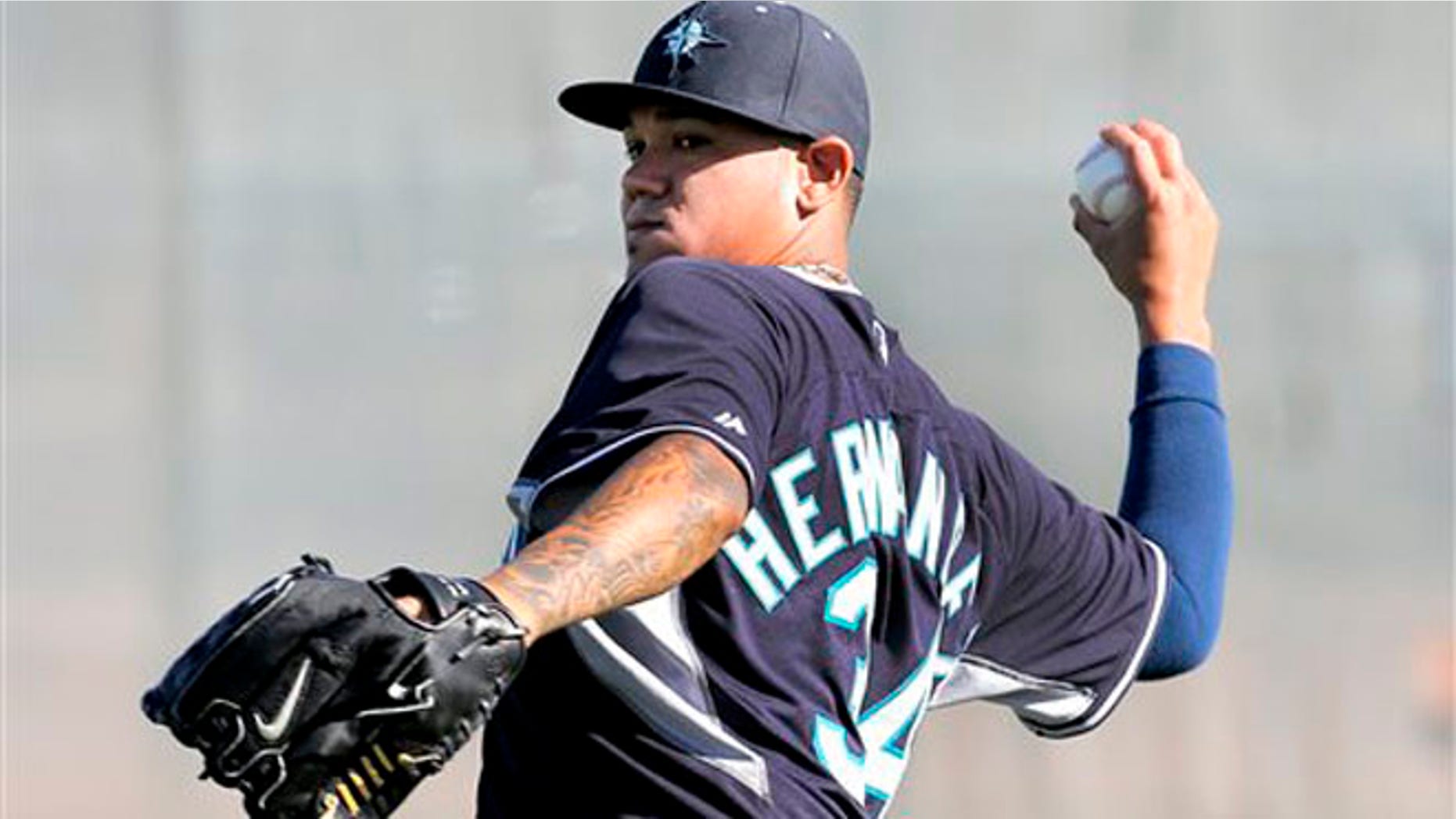 Seattle Mariners pitcher Felix Hernandez throws during their first spring training baseball practice, Thursday, Feb. 13, 2014, in Peoria, Ariz. (AP Photo/Matt York)