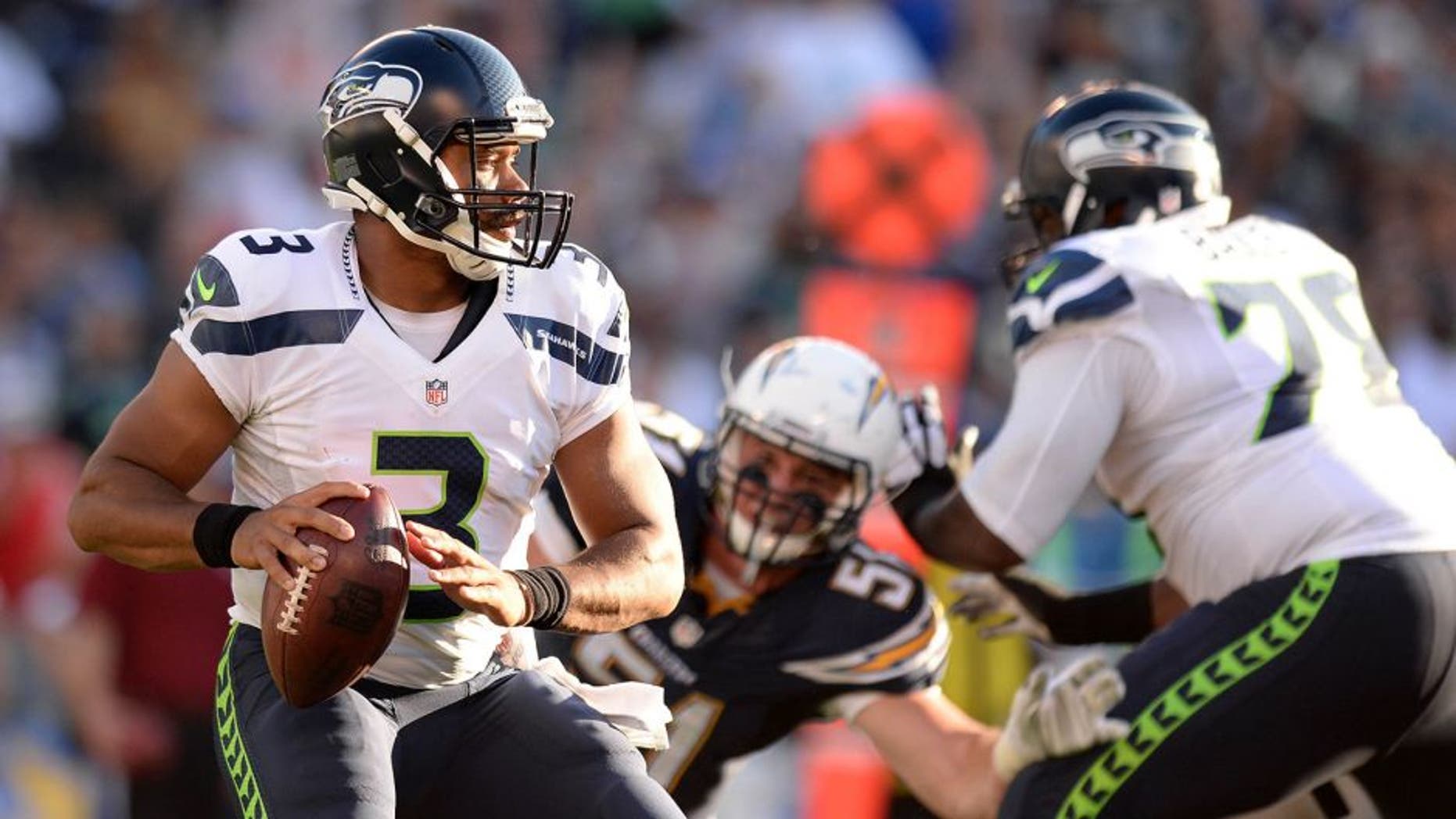 Aug 29, 2015; San Diego, CA, USA; Seattle Seahawks quarterback Russell Wilson (3) drops back to pass during the second quarter against the San Diego Chargers at Qualcomm Stadium. Mandatory Credit: Jake Roth-USA TODAY Sports