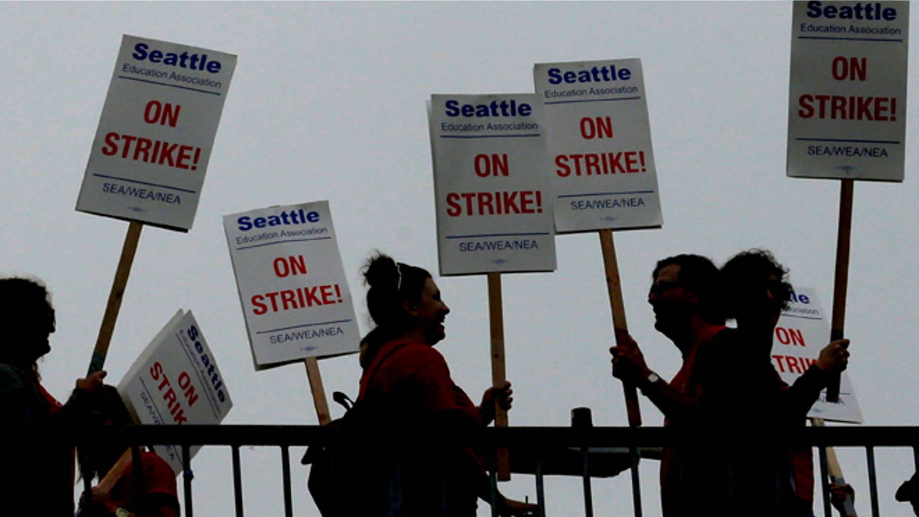 Sept 10: Striking Seattle School District teachers and other educators walk a picket line on a pedestrian overpass.