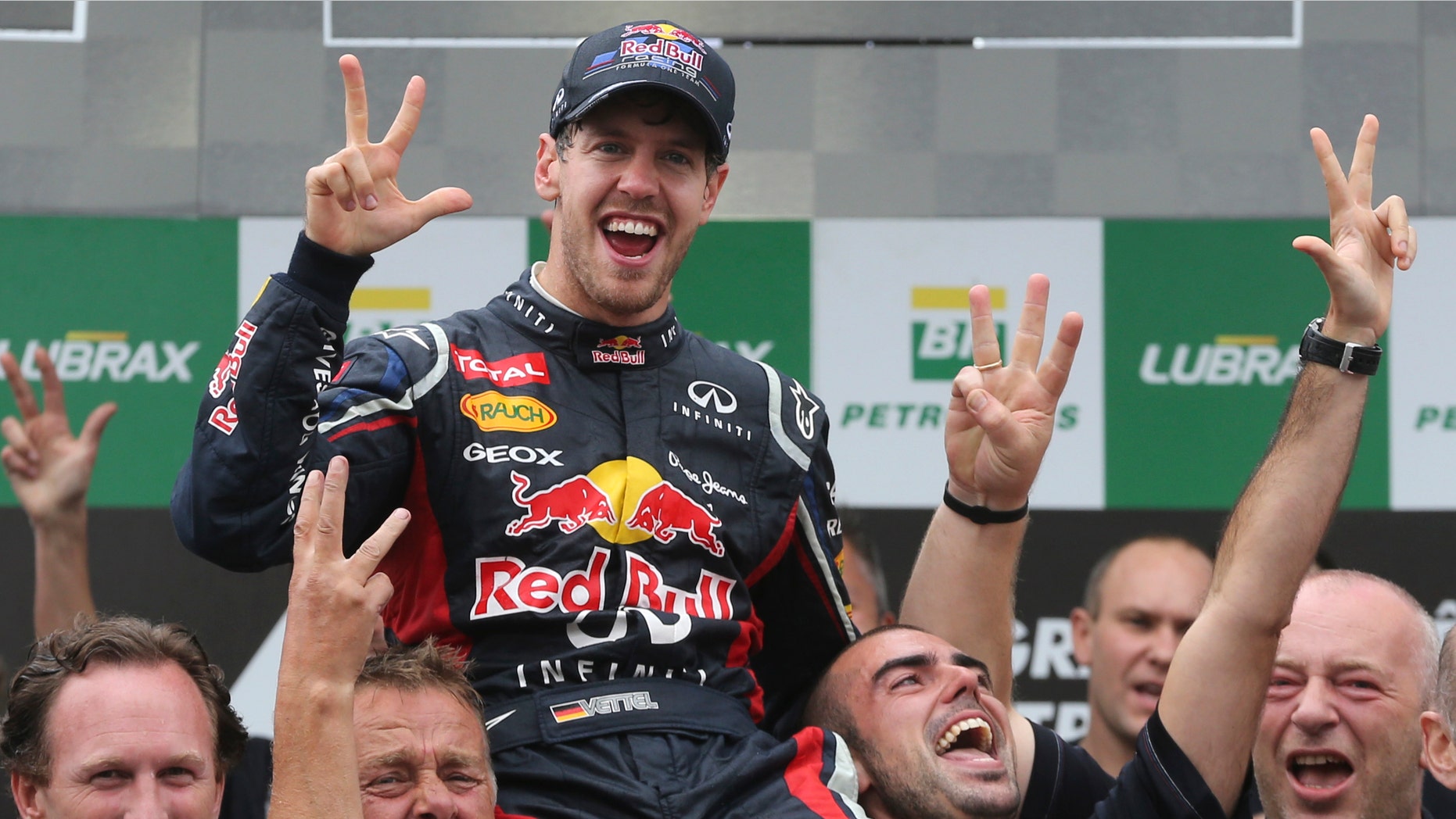 Red Bull driver Sebastian Vettel, center, of Germany, celebrates with members of his team after the Formula One Brazilian Grand Prix at the Interlagos race track in Sao Paulo, Brazil, Sunday, Nov. 25, 2012. (AP Photo/Andre Penner)