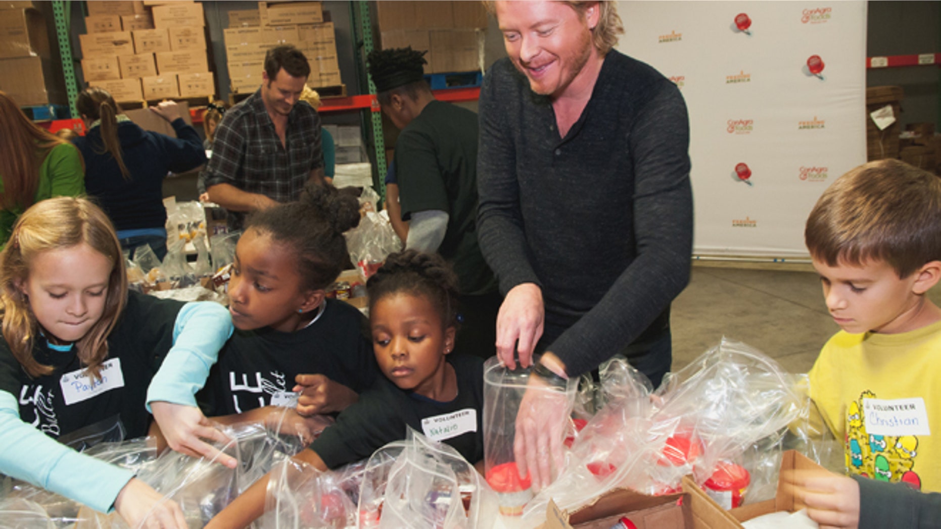 Nov.13, 2012: Phillip Sweet, center, and Nashville area children stuff backpacks in support of the Second Harvest Food Bank of Middle Tennessee Backpack program.