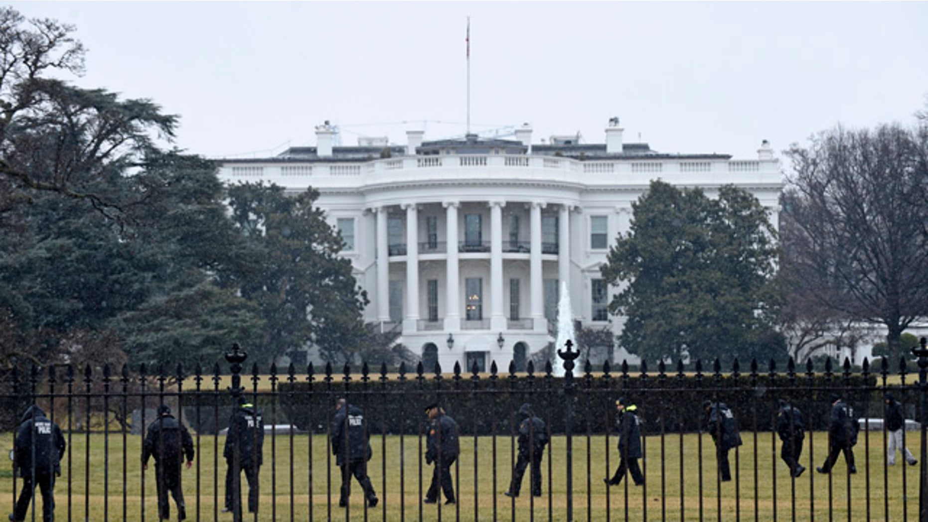 FILE - In this Jan. 26, 2015 file photo, Secret Service officers search the south grounds of the White House in Washington after an unmanned aerial drone was found on the White House grounds during the middle of the night. (AP Photo/Susan Walsh, File)