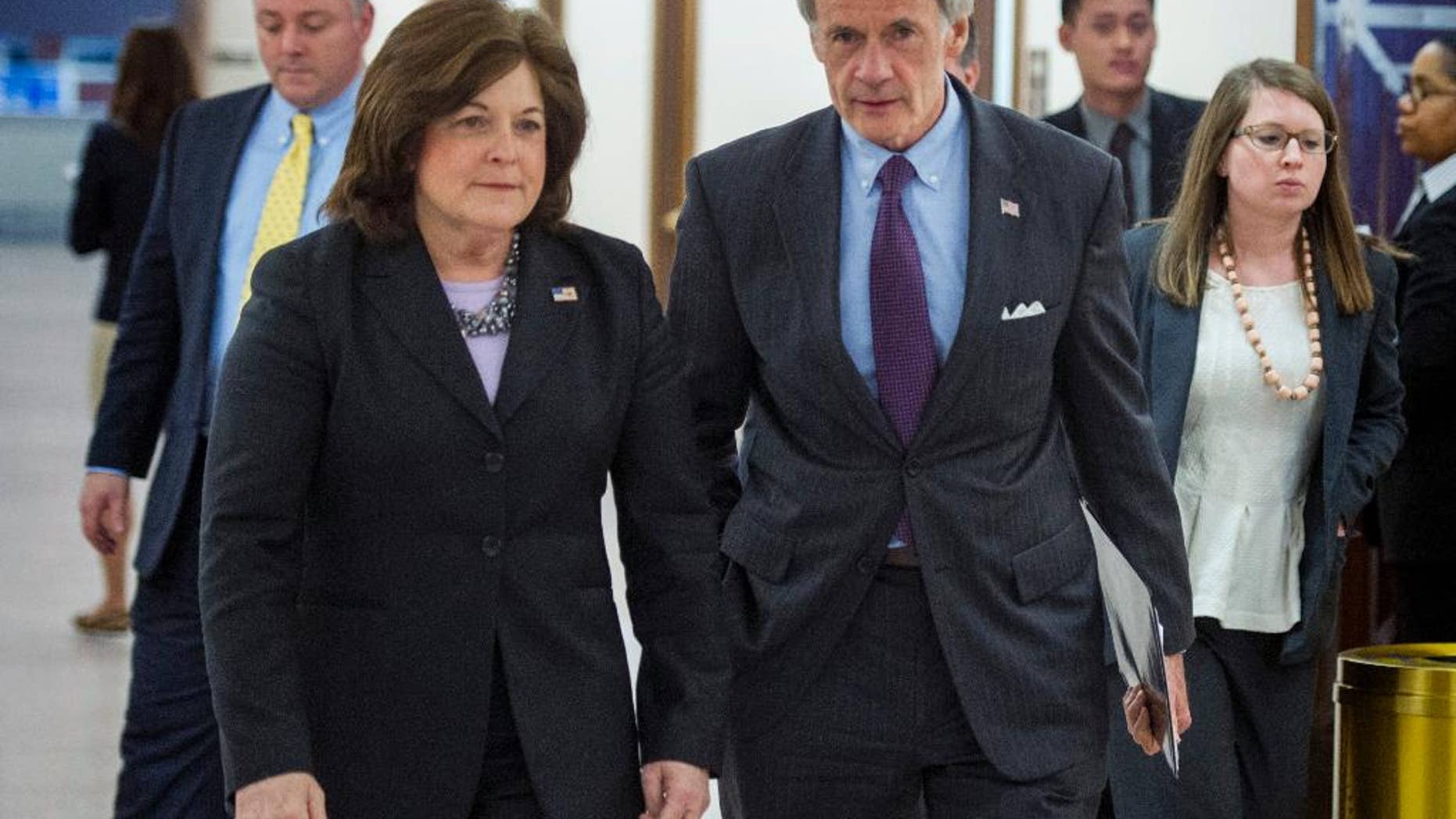 United States Secret Service director Julia Pierson and Senate Homeland Security Committee Chairman Tom Carper, D-Del., leave a committee hearing on recent Secret Service agents behavior, on Capitol Hill in Washington, Tuesday, April 1, 2014. (AP Photo/Cliff Owen)
