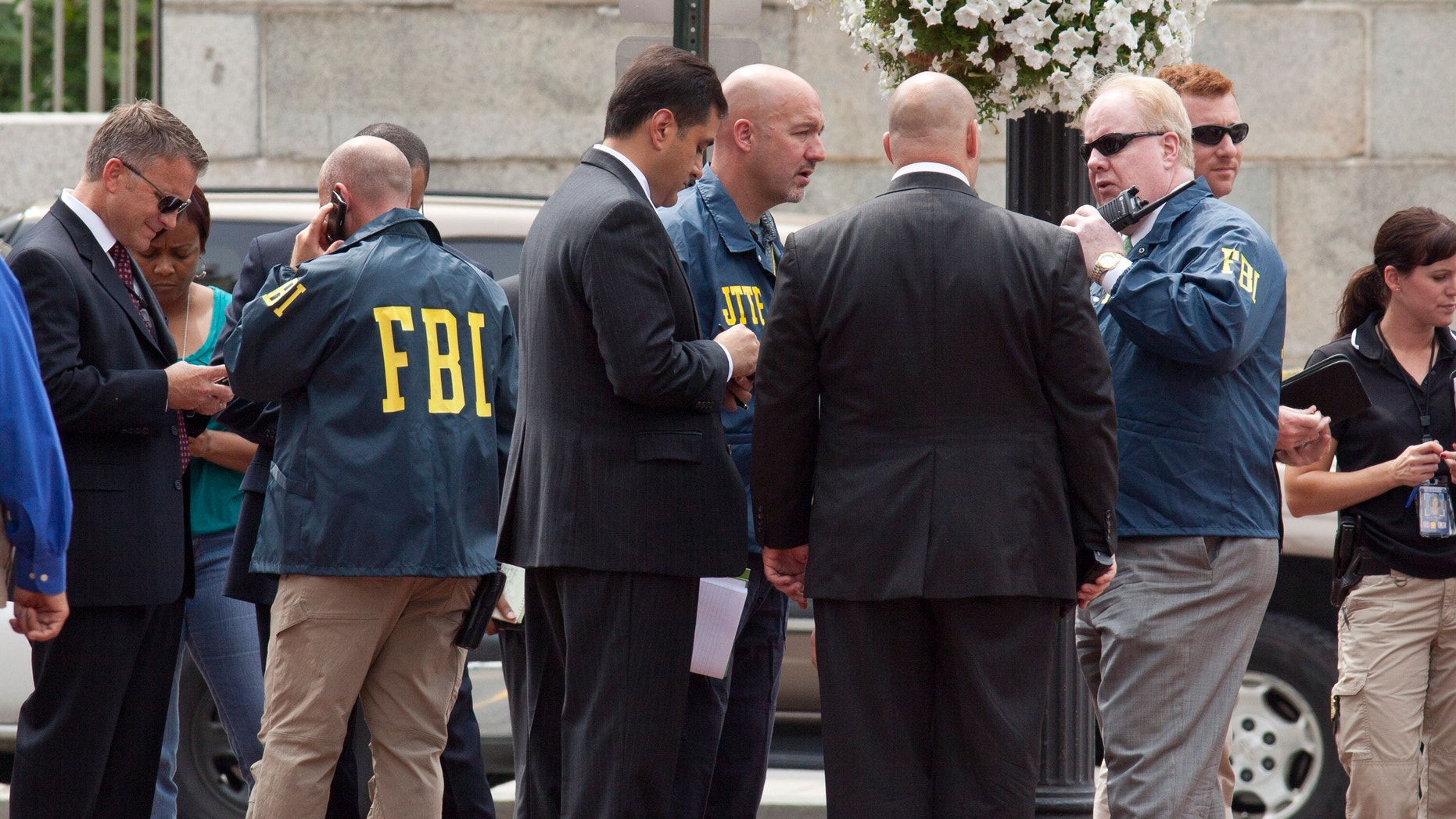 Aug. 15, 2012: Washington Police and FBI agents gather outside the Family Research Council in Washington.