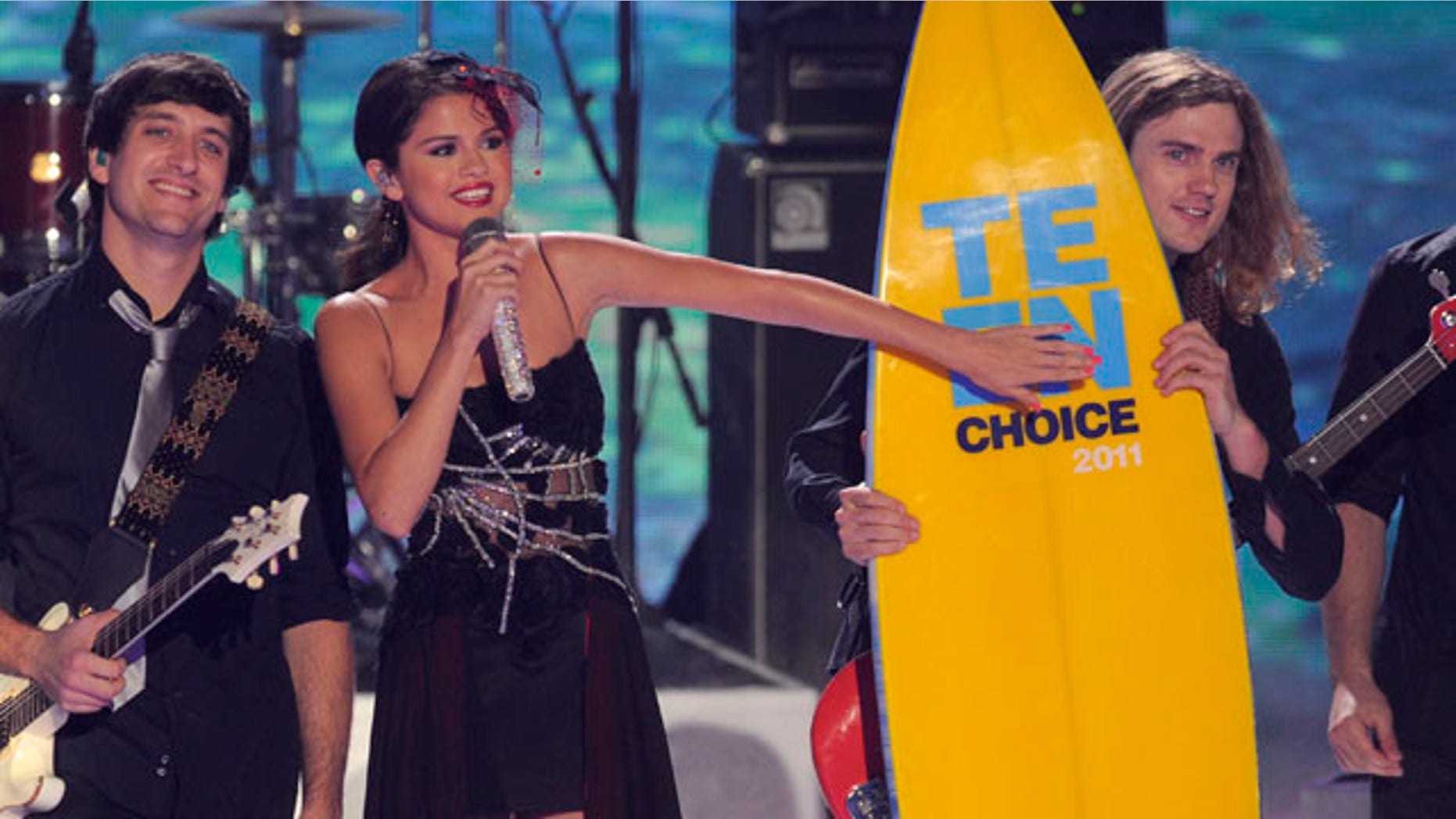 Aug. 7, 2011: Selena Gomez, center, accepts her award onstage at the Teen Choice Awards on Sunday in Universal City, Calif.
