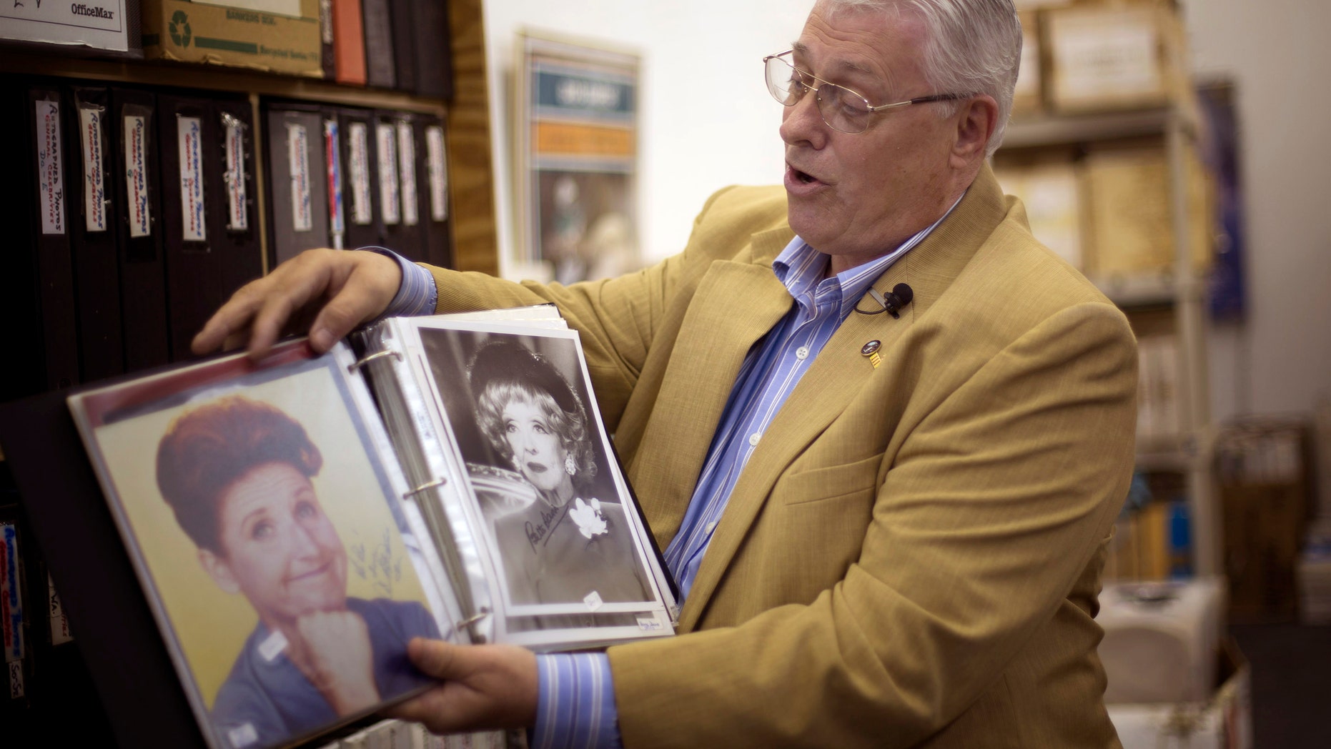 Oct. 19, 2012: Memorabilia collector Ken Kallin shows off autographed photos of Ann B. Davis, left, and Betty Davis, at his Oakland Park, Fla. office. Three decades ago, Kallin began amassing 120,000 pieces in a memorabilia collection that includes photographs signed by Muhammad Ali and Neil Armstrong along with rare books and trading cards.