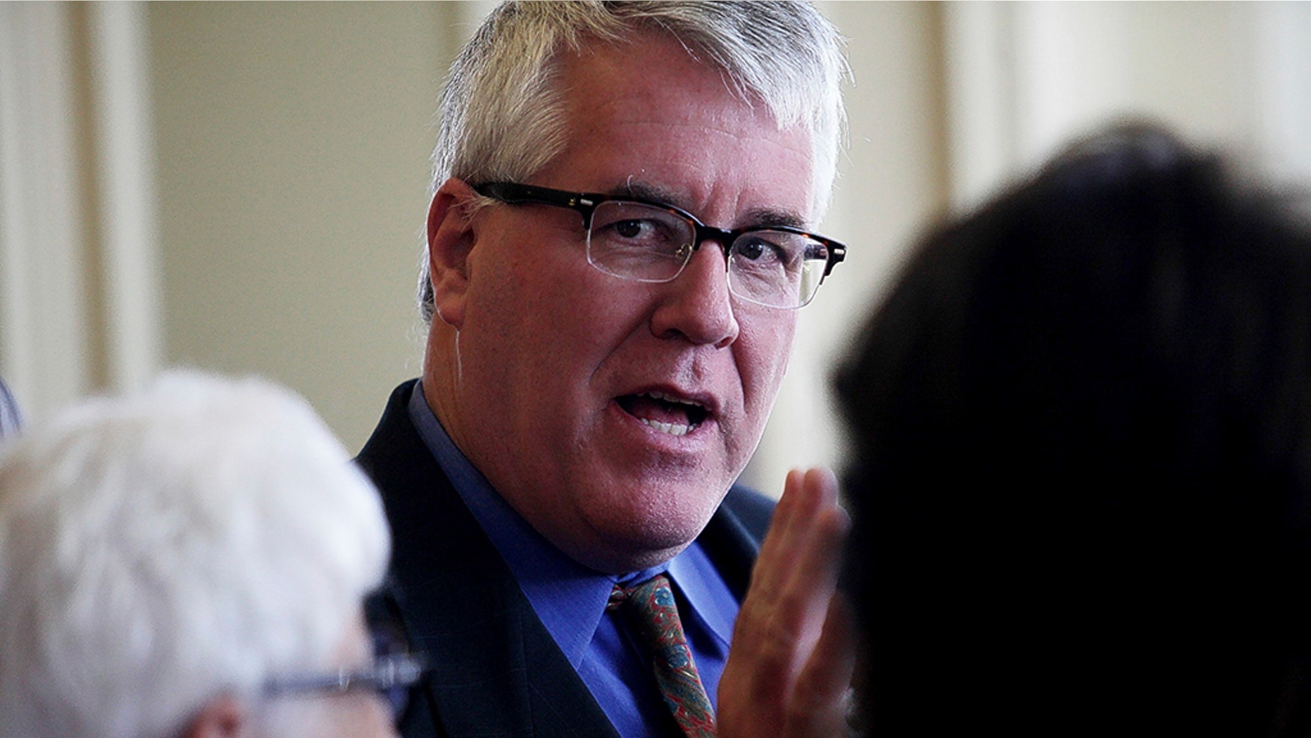 In this April 17, 2014 photo, State Sen. Jeff Woodburn, a Democrat from Dalton, speaks with other Democratic senators during a recess in the Senate chamber in Concord, N.H. Woodburn, the minority leader in the New Hampshire Senate has been arrested for allegedly hitting a woman, biting her on the arm and kicking in the door of her house.