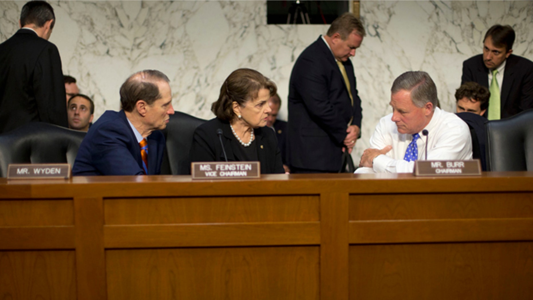 FILE - In this Sept. 24, 2015 file photo, Senate Intelligence Committee Chairman Sen. Richard Burr, R-N.C., right, confers with committee Vice-Chair. Sen. Dianne Feinstein, D-Calif., center, and committee member Sen. Ron Wyden, D-Ore., on Capitol Hill in Washington. (AP Photo/Pablo Martinez Monsivais)