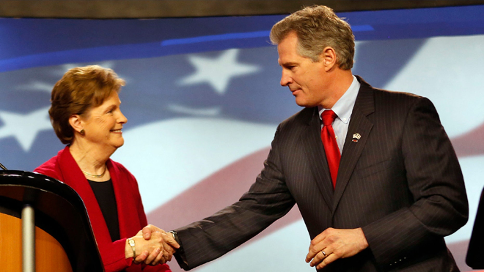 In this Thursday, Oct., 2014 photo, Democrat, U.S. Sen Jeanne Shaheen, left, shakes hands with her Republican opponent former Massachusetts U.S. Sen. Scott Brown before a live televised debate for U.S. Senate.