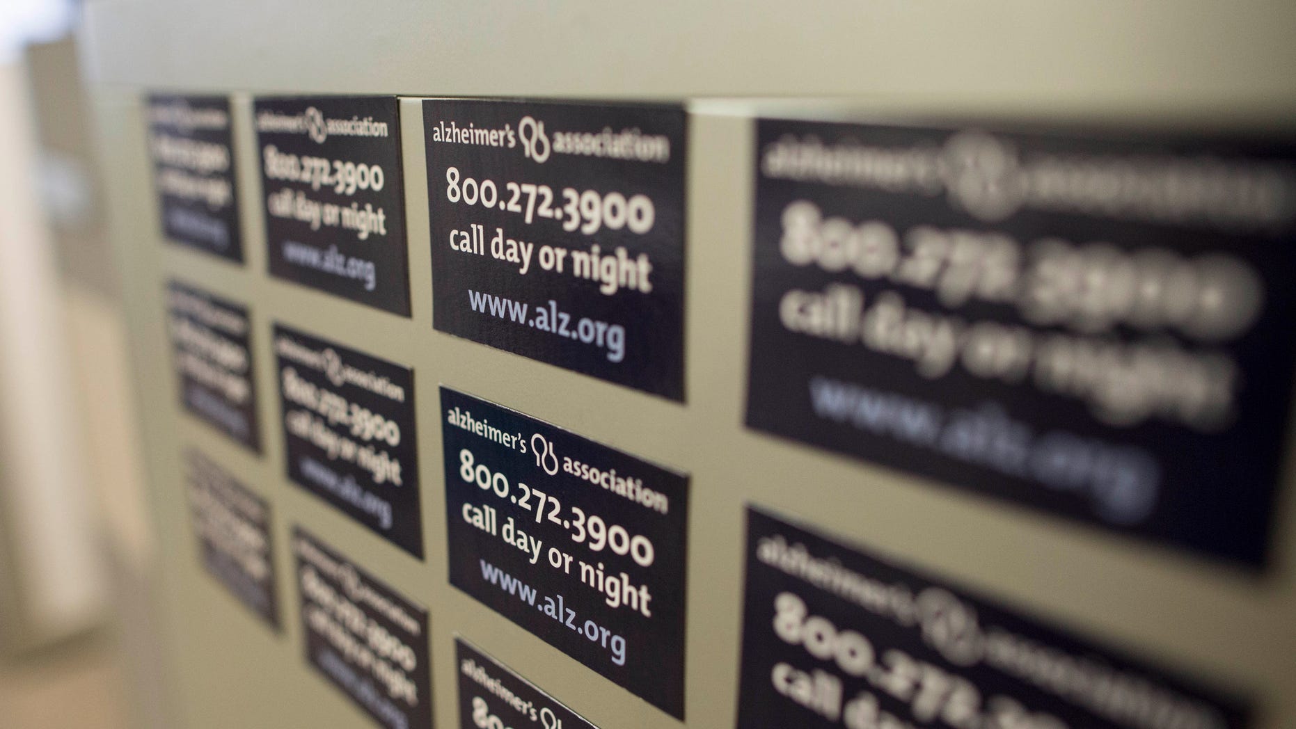 Magnets on a cabinet at the Alzheimer's Association Headquarters in Chicago advertising their help line.