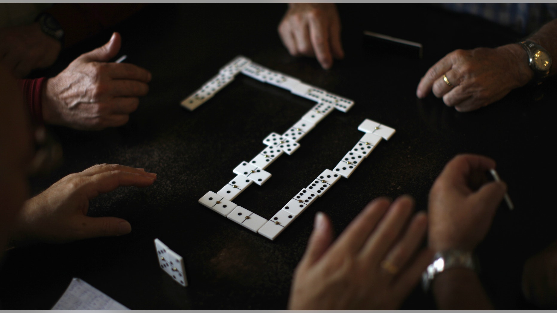 Pensioners play dominoes at a seniors centre during the International Day of Older Persons.