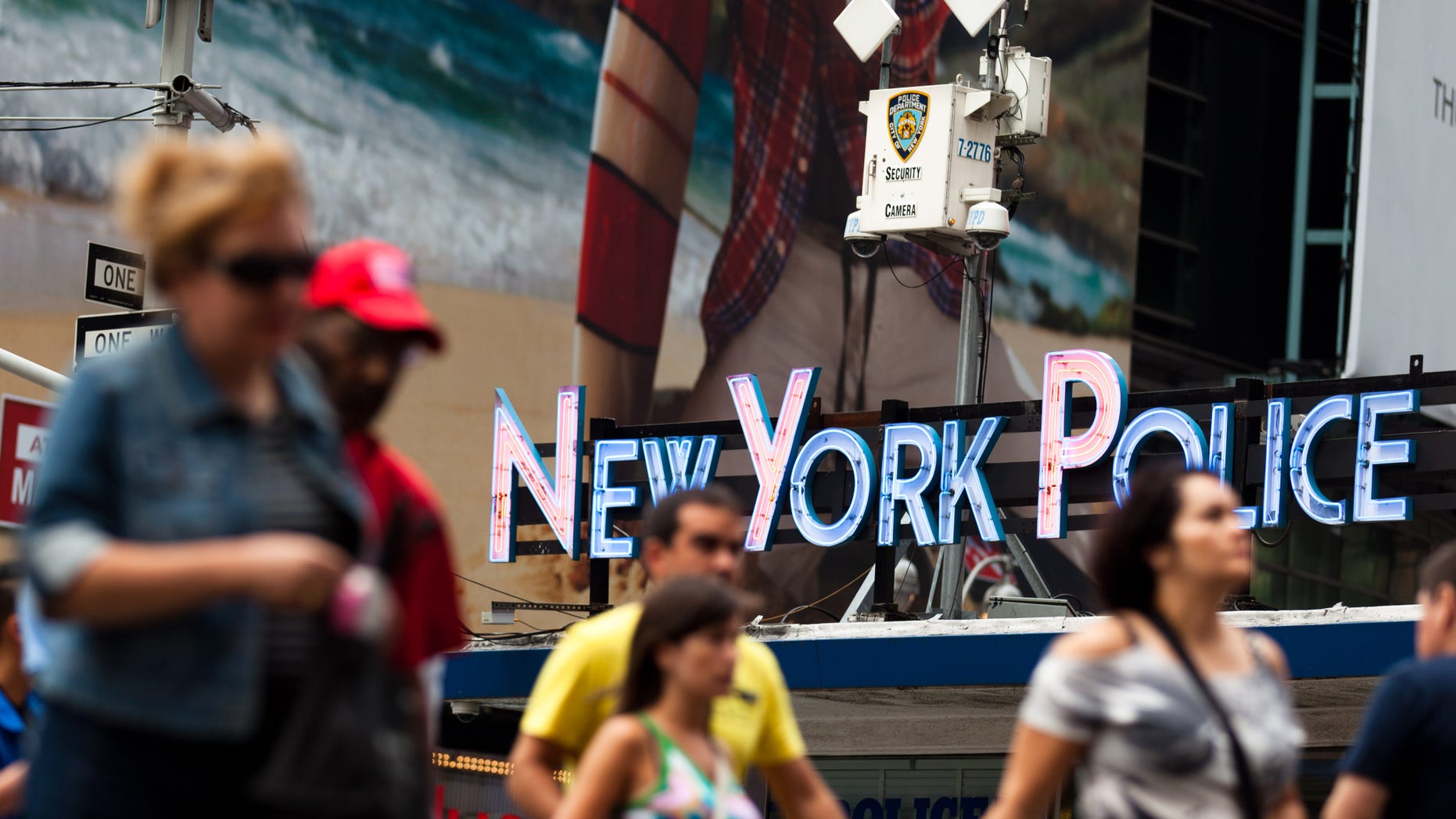 Pedestrians start their morning under the watchful eyes of surveillance cameras in Times Square in New York, Tuesday, Aug. 19, 2011. Since the terrorist attacks of Sept. 11, 2001, the NYPD has become one of the country's most aggressive domestic intelligence agencies, targets ethnic communities in ways that would run afoul of civil liberties rules if practiced by the federal government. (AP Photo/John Minchillo)