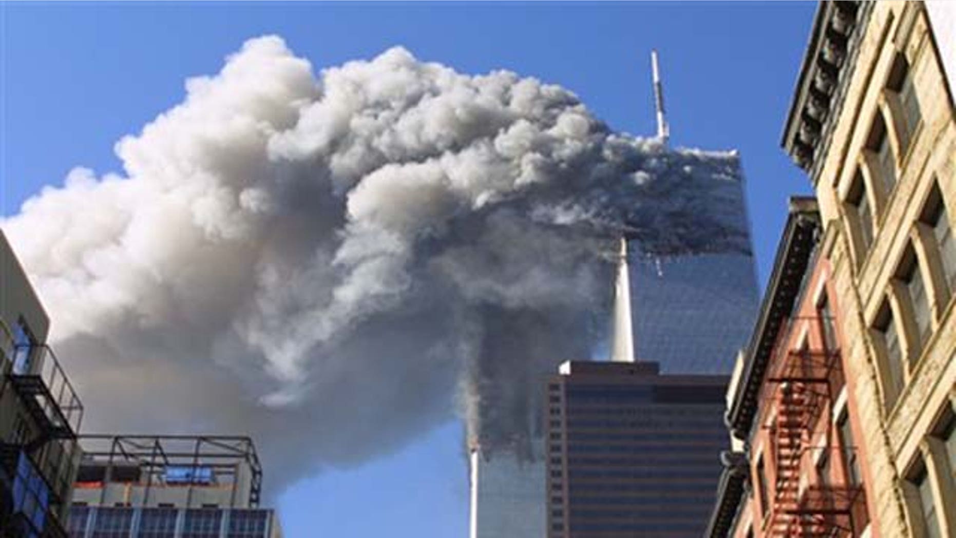 FILE - In this Sept. 11, 2001 file photo, the twin towers of the World Trade Center burn after hijacked planes crashed into them in New York. As the post-Sept. 11 decade ends, some foreign families of the victims are eager to move past the tragedy. But though the pain transcended borders, foreign families have battled to cope with their loss from afar.