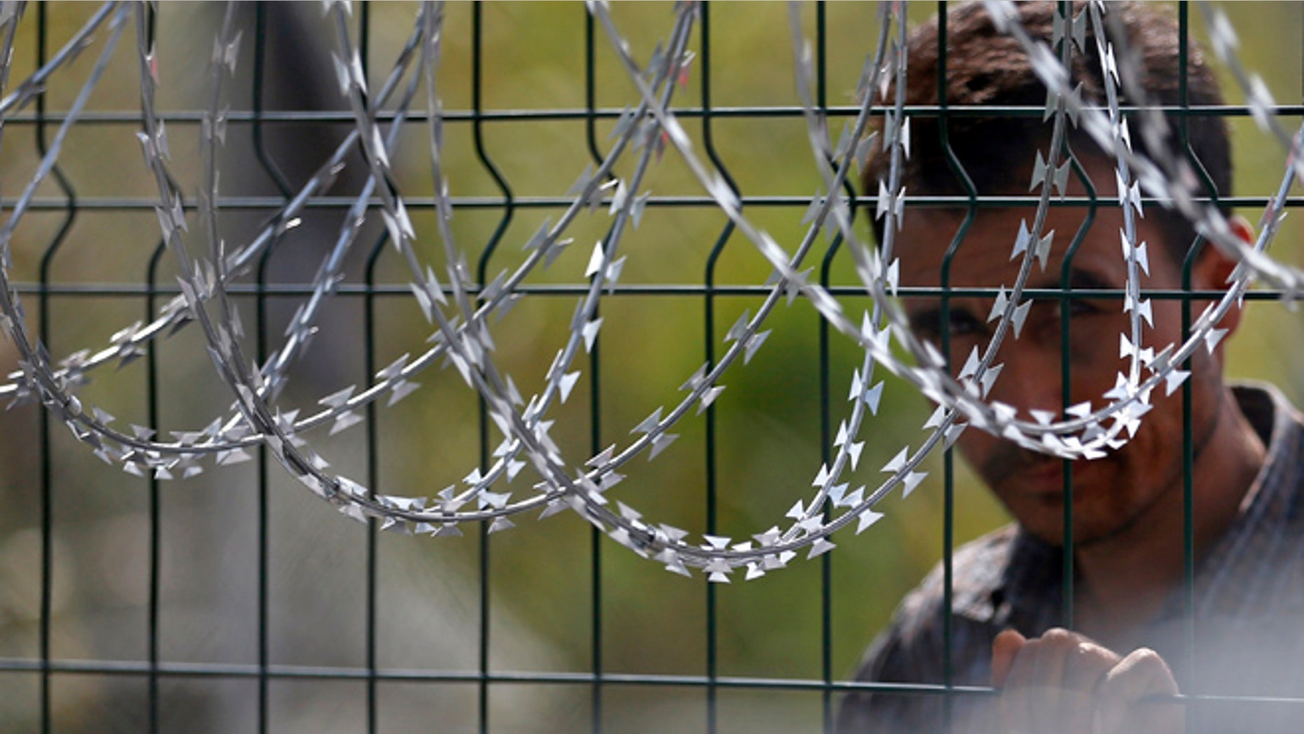 Sept. 16, 2015: A refugee waiting at the Hungary-Serbia border.