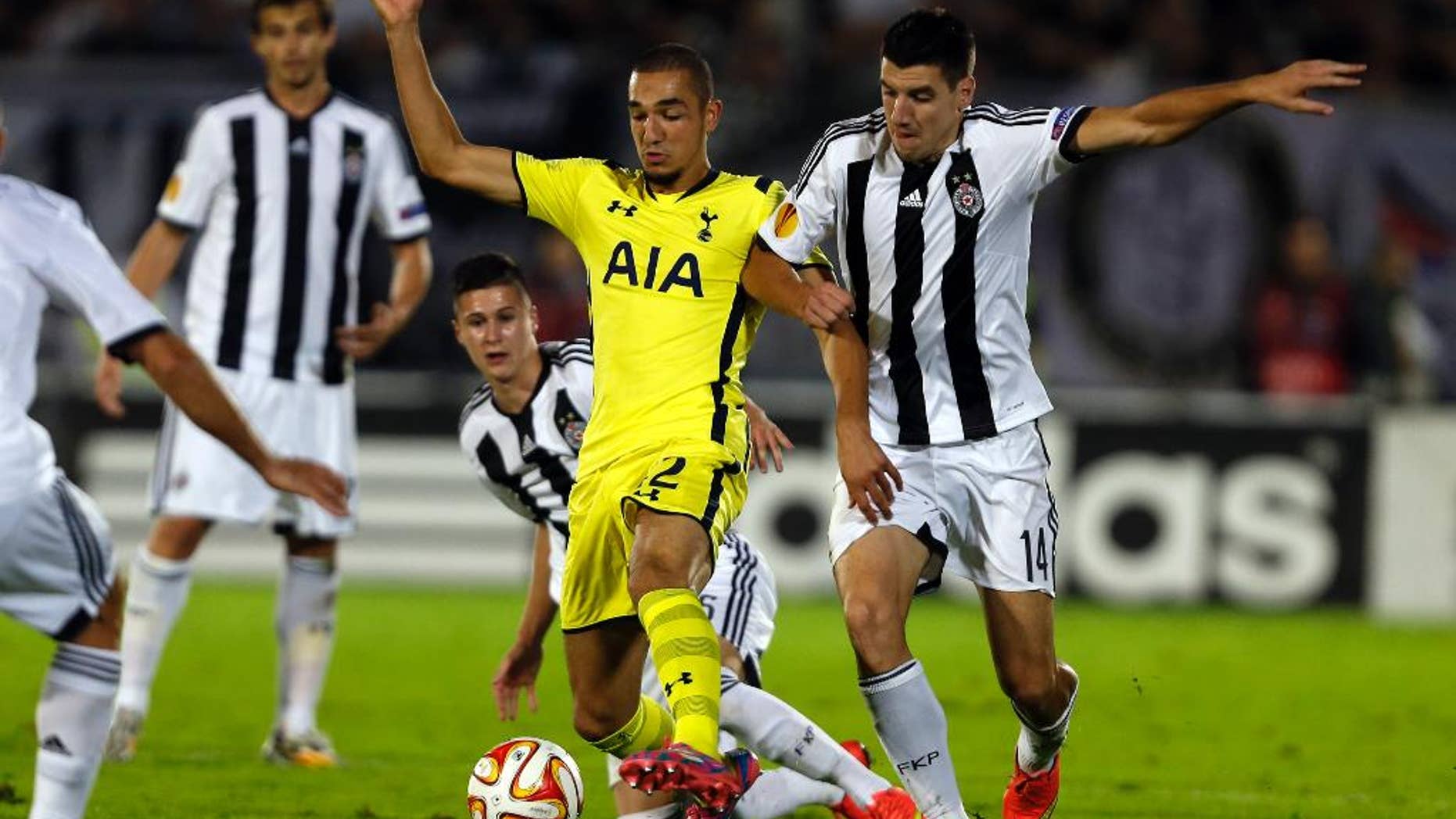 Tottenham Hotspur's Nabil Bentaleb, center, and Partizan Belgrade's Petar Grbic, right, challenge for the ball during the Europa League Group C soccer match between Partizan Belgrade and Tottenham Hotspur in Belgrade, Serbia, Thursday, Sept. 18, 2014. (AP Photo/Marko Drobnjakovic)