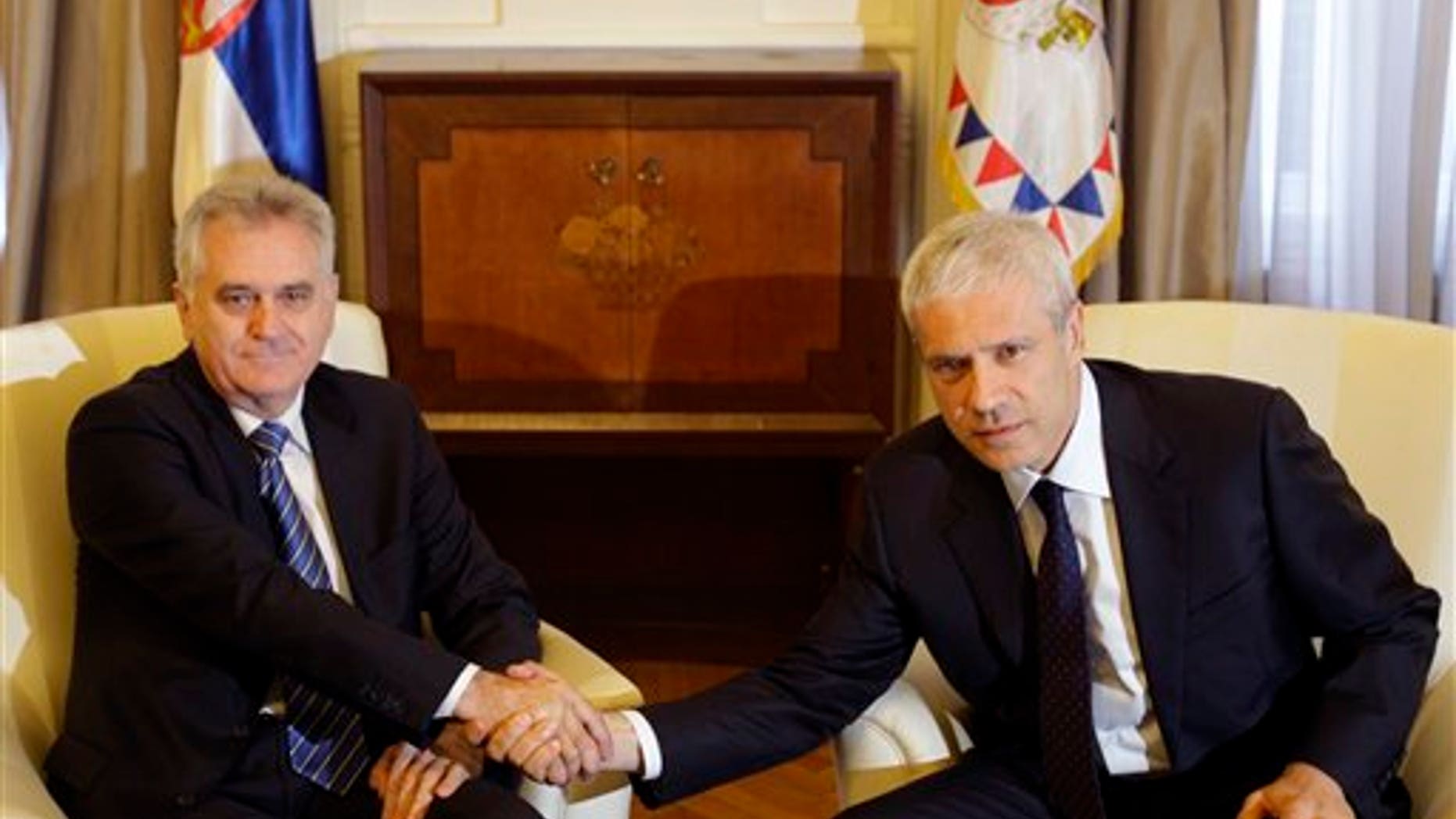 May 28, 2012: Newly elected Serbian President Tomislav Nikolic, left, shakes hands with former president Boris Tadic during meeting in the Serbian presidency building, in Belgrade, Serbia.