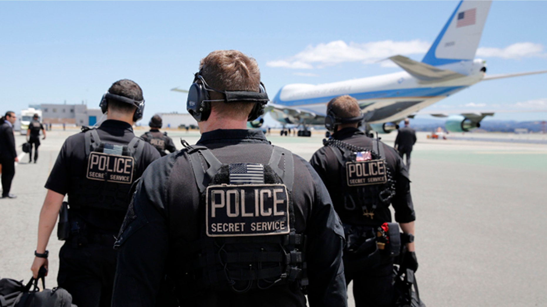 FILE: July 23, 2014: U.S. Secret Service employees walk toward Air Force One at San Francisco International Airport, San Francisco, Calif.