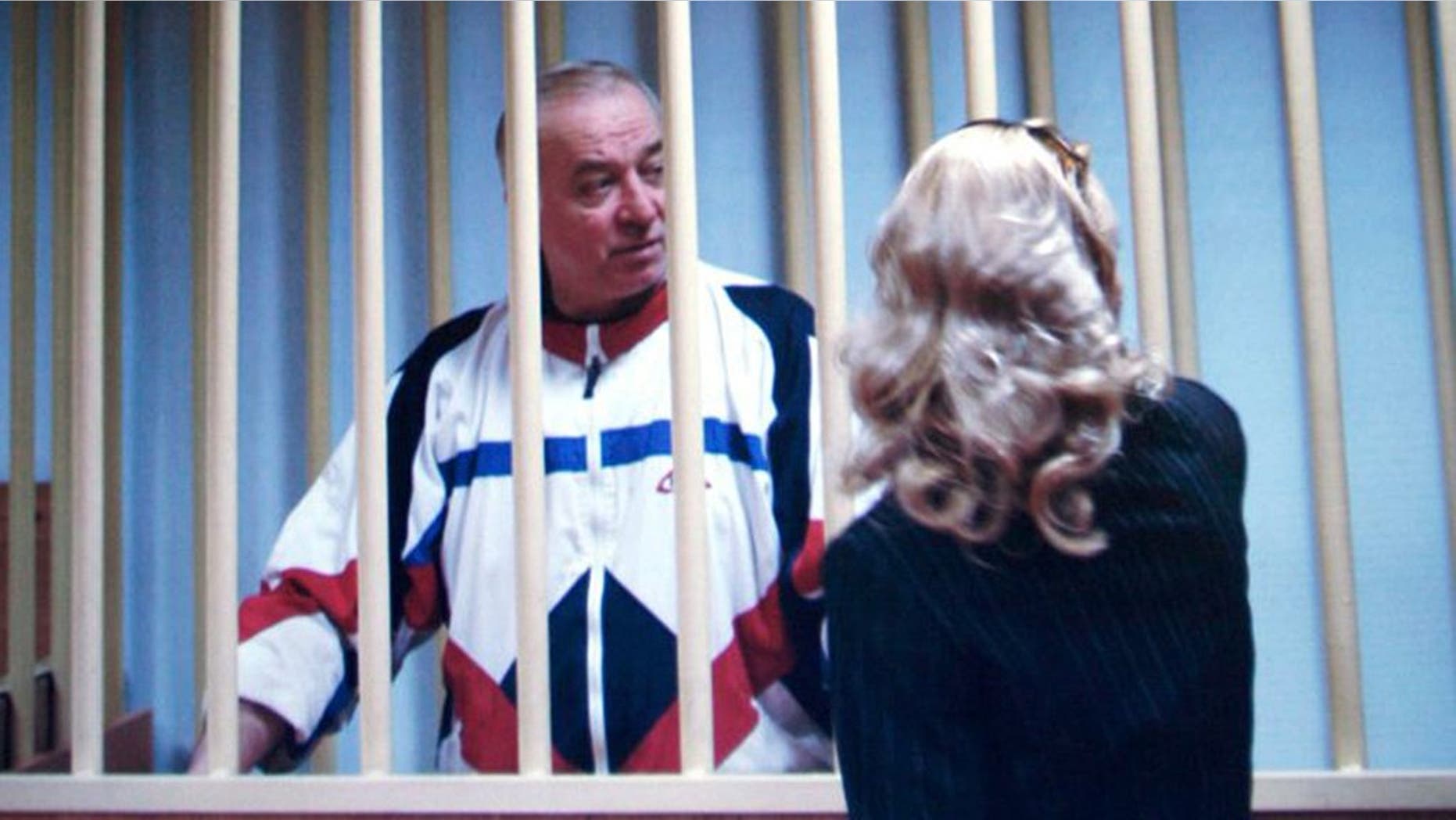 Sergei Skripal speaks to his lawyer from behind bars seen on a screen of a monitor outside a courtroom in Moscow on Wednesday, Aug. 9, 2006. Skripal a retired Russian colonel recruited by British intelligence in the mid-1990s was sentenced Wednesday by a military court in Moscow to 13 years imprisonment for spying, officials said. (AP Photo/Misha Japaridze)