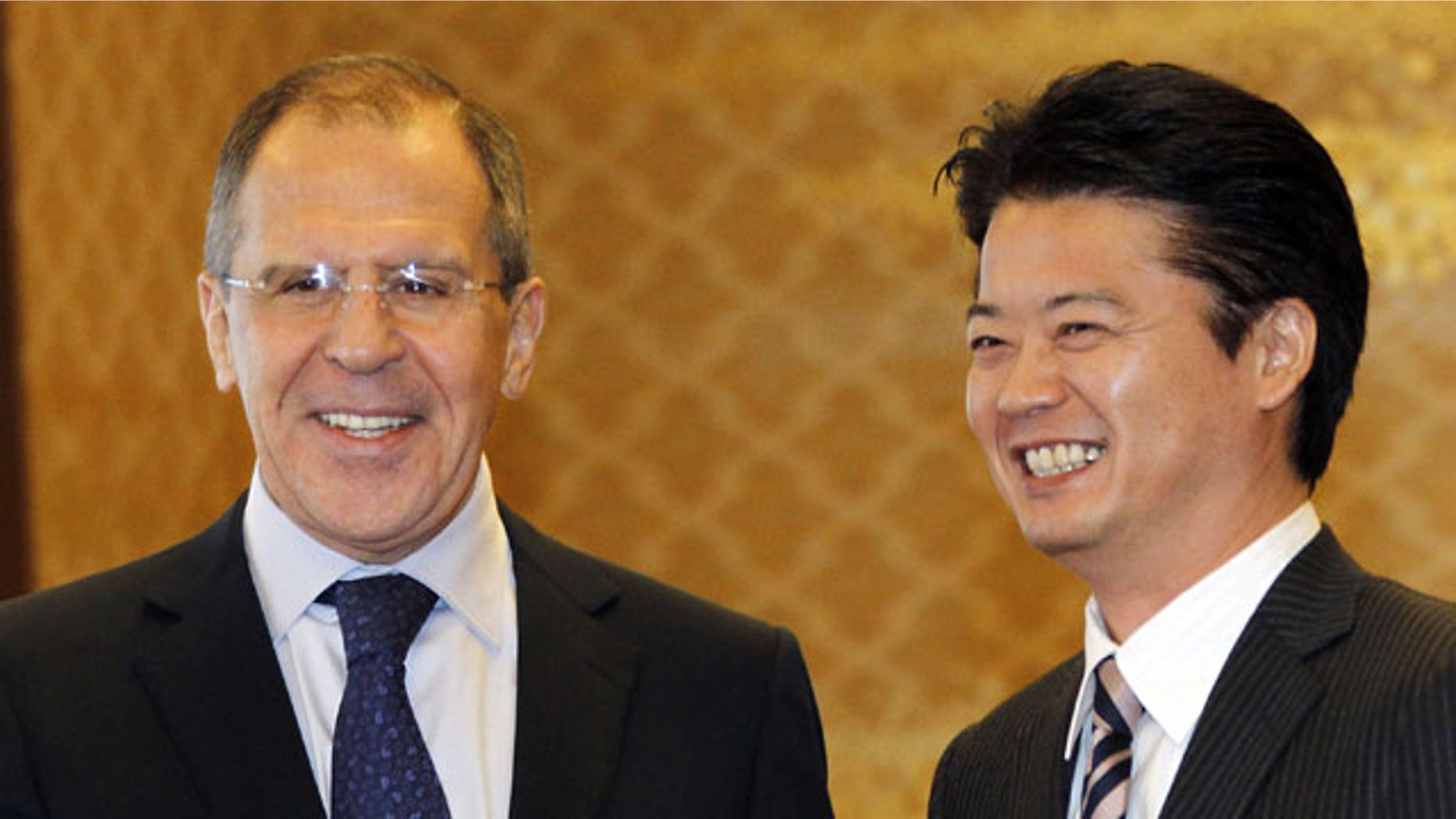 January 28, 2012: Russian Foreign Minister Sergey Lavrov, left, shakes hands with his counterpart Koichiro Gemba prior to their meeting in Tokyo.