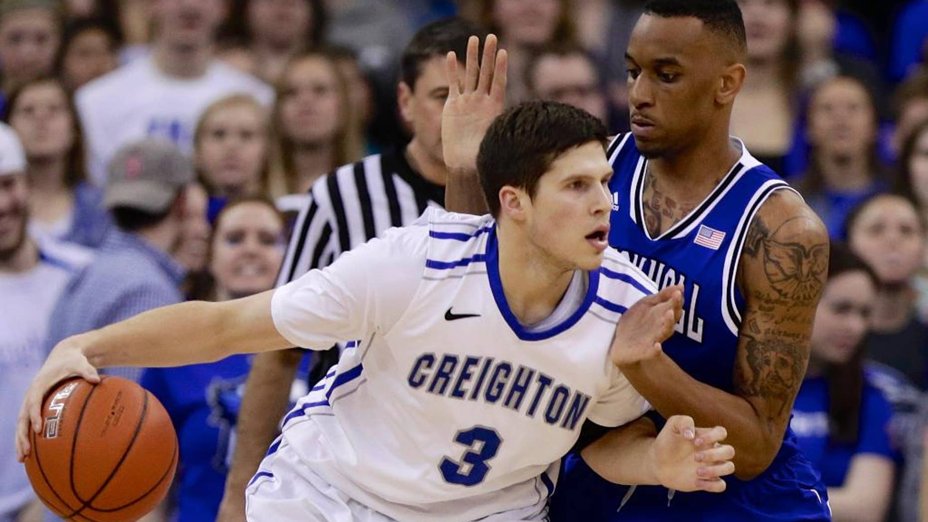 Creighton's Doug McDermott (3) drives around Seton Hall's Brandon Mobley (2) in the first half of an NCAA college basketball game in Omaha, Neb., Sunday, Feb. 23, 2014. (AP Photo/Nati Harnik)