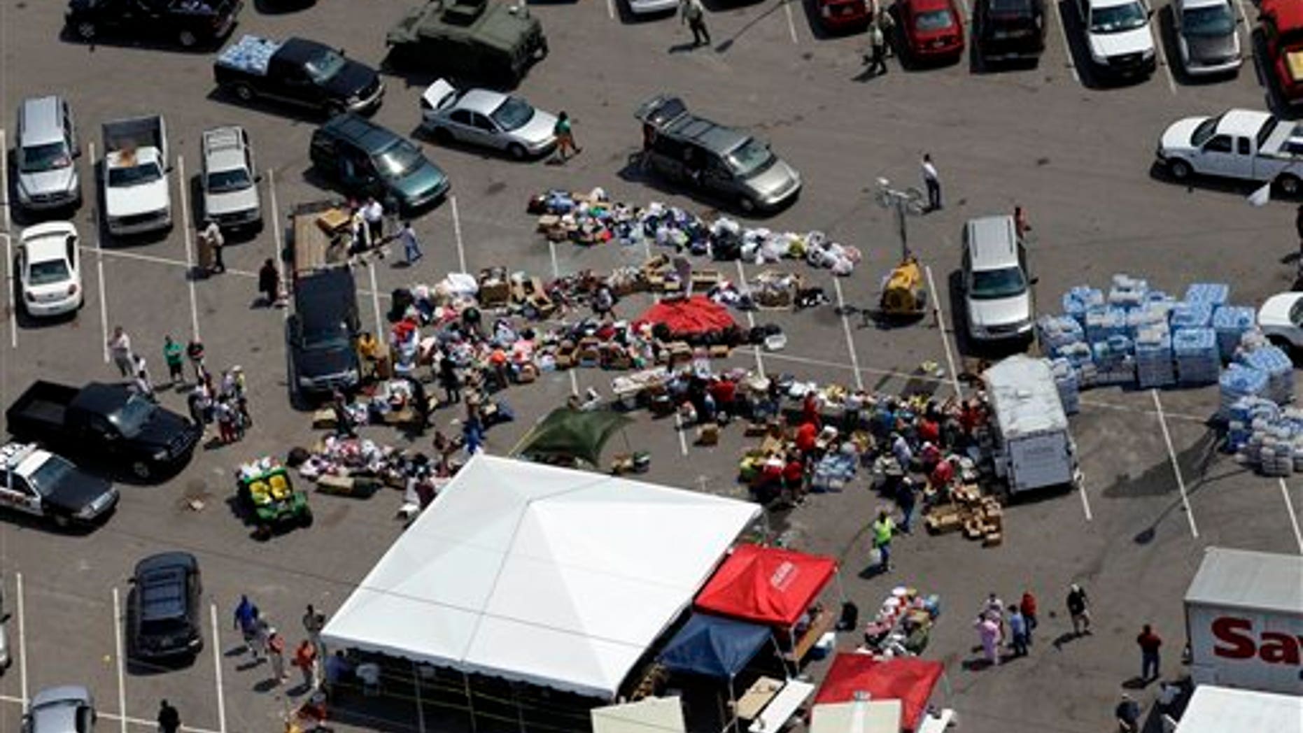 April 30: Tuscaloosa residents gather in a parking lot where food, water, and supplies are being distributed to those in need in Tuscaloosa, Ala.. (AP)